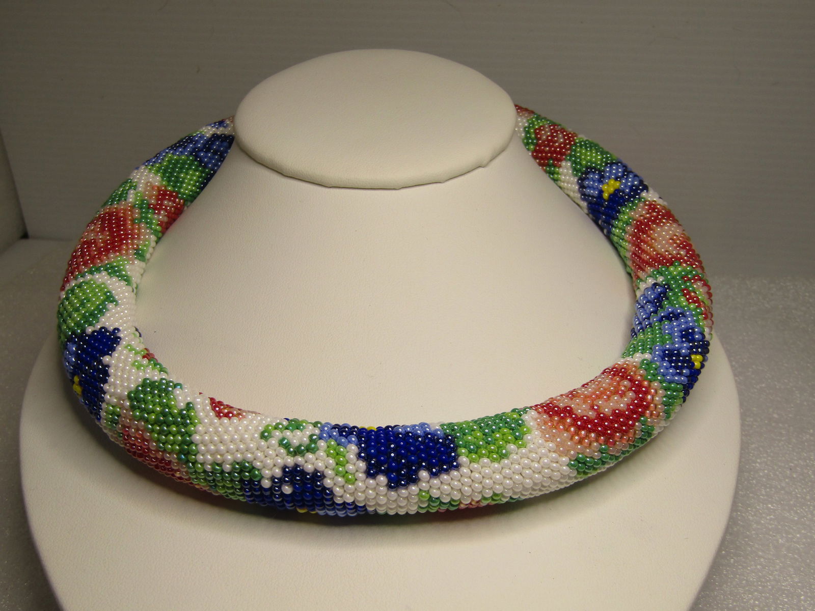 Floral Seed Beaded Tubular Hand Beaded Necklace, 19"-23", 1980's-1990's: Floral Seed Beaded Tubular Hand Beaded Necklace, 19"-23", 1980's-1990's. This is approximately 17.5mm wide and a round tubular design with a stuffed center to hold the shape. All beads are glass