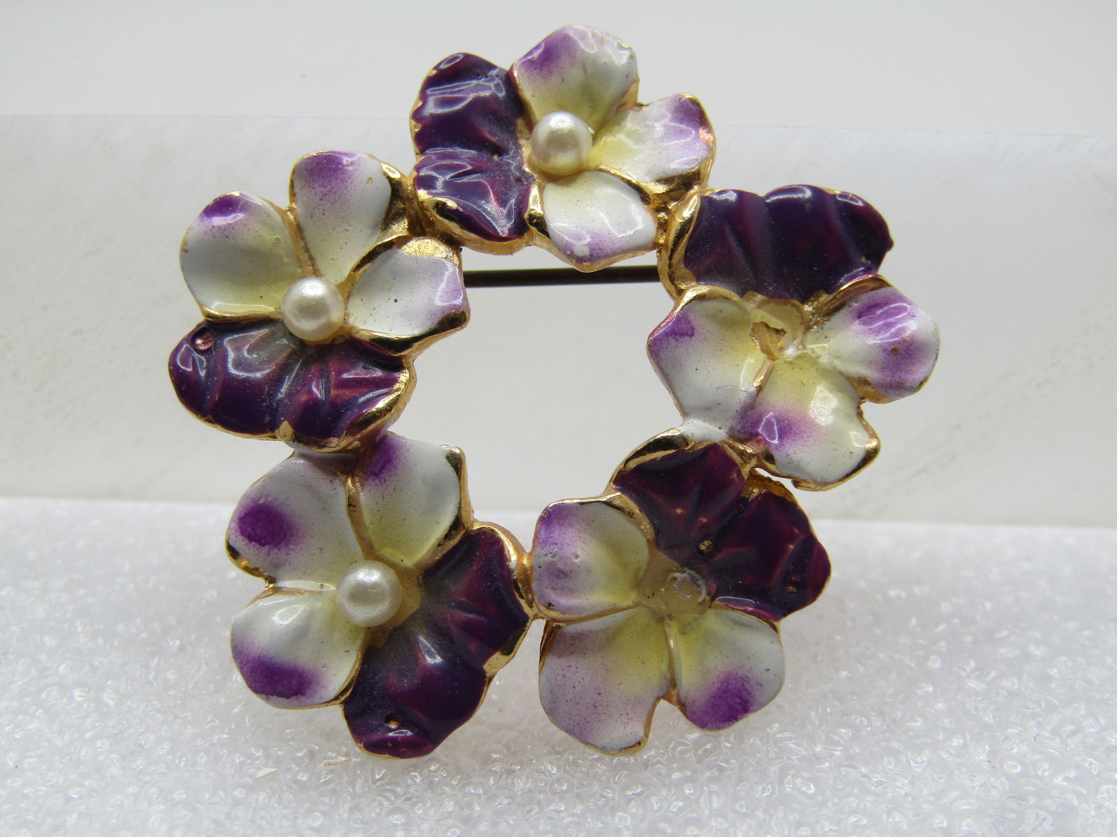 Vintage Enameled Violets Circle Brooch, Faux Pearl Centers, 1960's: Vintage Enameled Violets Circle Brooch, Faux Pearl Centers, 1960's. This is gold tone with enameling on the front in white, lavender and shaded purple on each of the five blossoms with a center