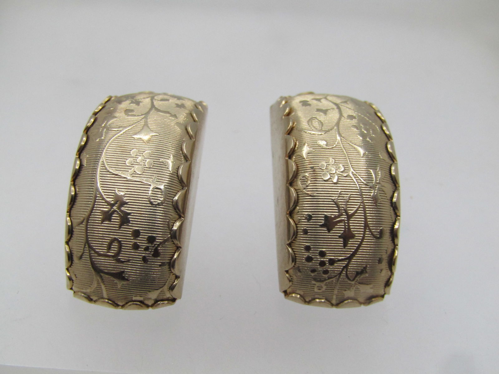 Vintage Floral Raised Curved Clip Earrings, 1960's: Vintage Floral Raised Curved Clip Earrings, 1960's. They are sllightly over 1" tall and 1/3" wide. Gold tone. They are not signed or marked and are in very good condition. (W111123.3 SS13444 J AZ