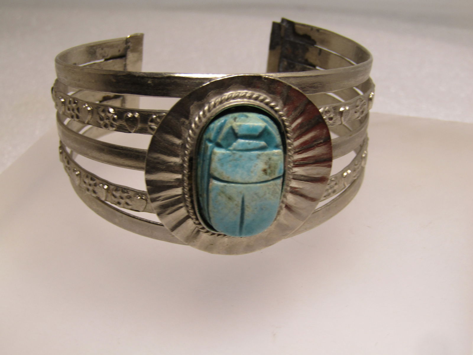 Vintage Egyptian Revival Scarab Cuff Bracelet, 7", 1960's-1970's: Vintage Egyptian Revival Scarab Cuff Bracelet, 7", 1960's-1970's Blue Scarab. This is an amulet blue faience scarab made from a ceramic type material. It is set in a bezel with rope accent and then wi