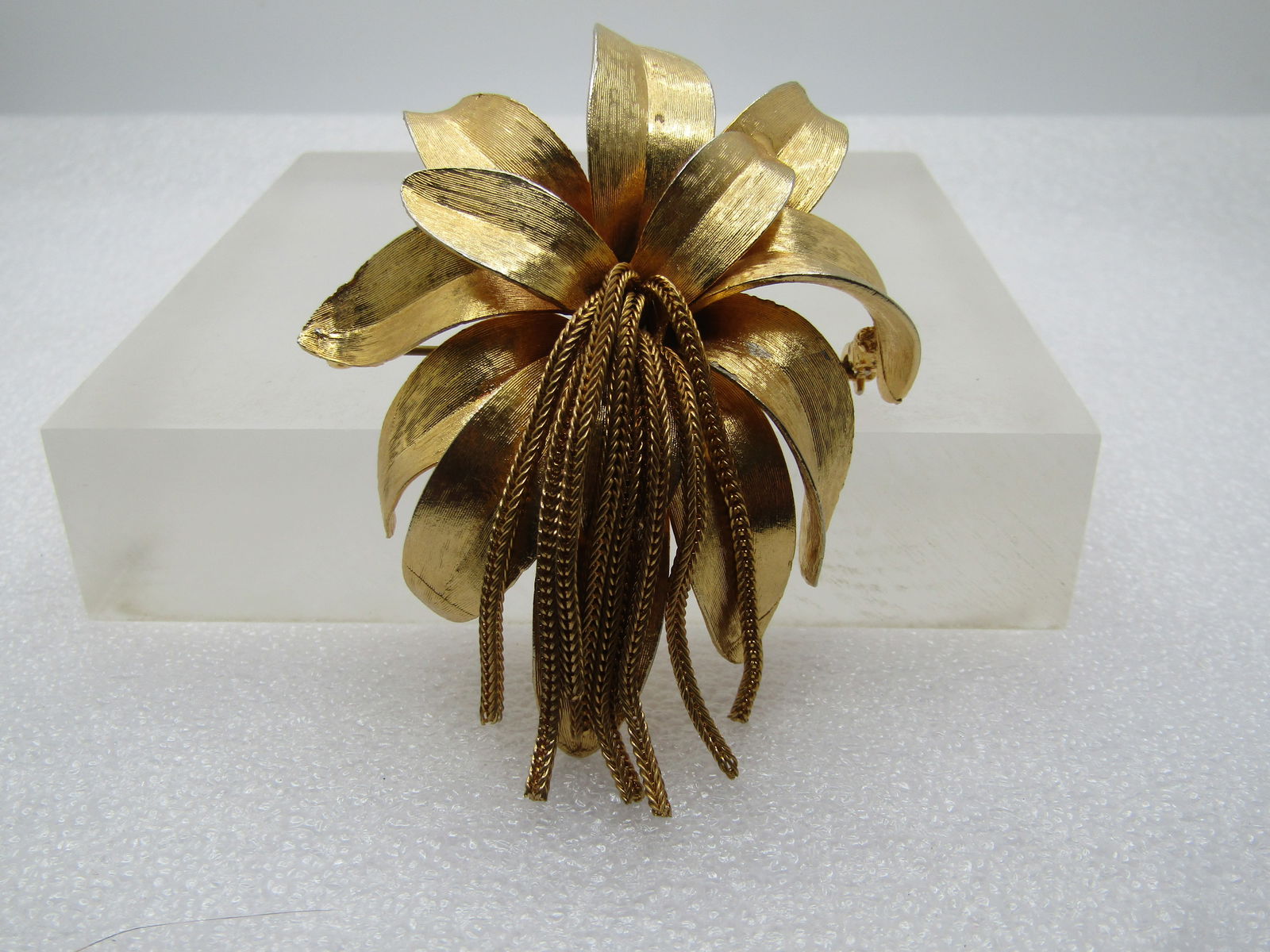 Vintage Floral Blossom Brooch with Foxtail Chain Tassels, 1960's: Vintage Floral Blossom Brooch with Foxtail Chain Tassels, 1960's. Bold brooch with petals that are ridge and sit lower down the center with a textured finish. Bright yellow gold and shiny. The