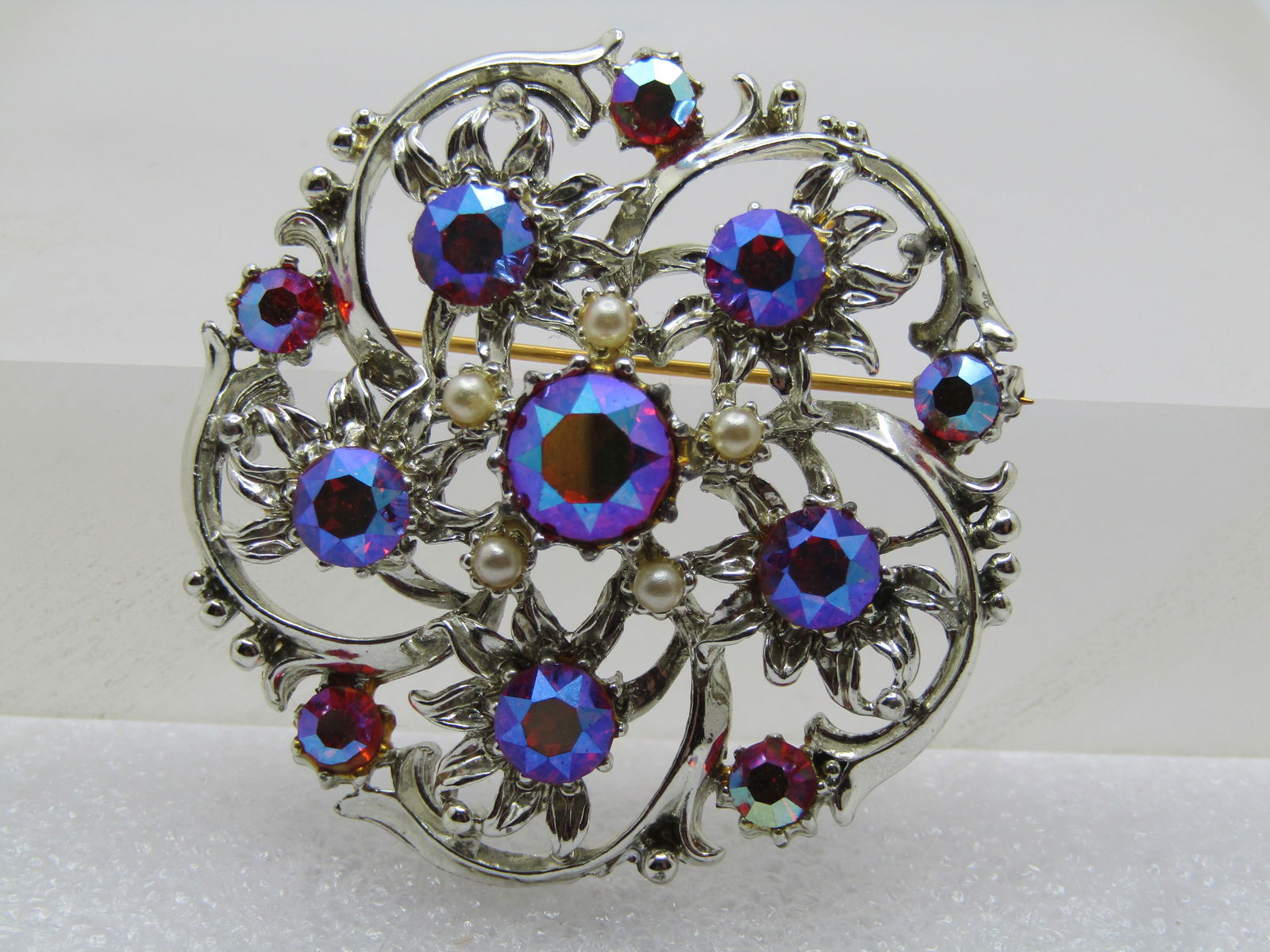 Vintage Pink AB Rhinestone Brooch, Blossom with Faux Pearls, 1960's: Vintage Pink AB Rhinestone Brooch, Blossom with Faux Pearls, 1960's. Silver tone with blossoms set around the center with an appx. 6mm pink AB rhinestone set in each and an appx. 4mm matching stone