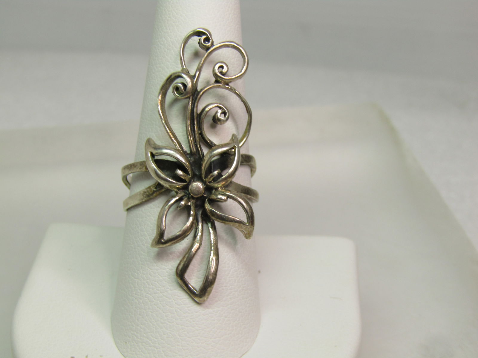 Vintage Sterling Long Floral Ring, Sz. 9.25. 1980's-1990's, Signed: Vintage Sterling Long Floral Ring, Sz. 9.25. 1980's-1990's, Signed with an unknown maker's mark. It has a blossom in the center with curled accents above the blsosom and a double boxed stem at the
