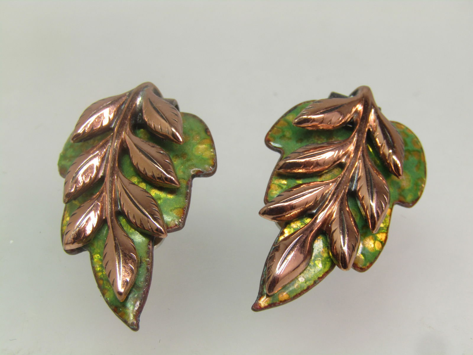 Vintage Copper Enameled Leaf Earrings. Clip, Signed Renoir, 1950's-1960's: Vintage Copper Enameled Leaf Earrings. Clip, Signed Renoir, 1950's-1960's. They are appx. 1-1/8" long nad 3/4" wide with an overlay of a leaf stem with pointed leafs with etched detail in the tips