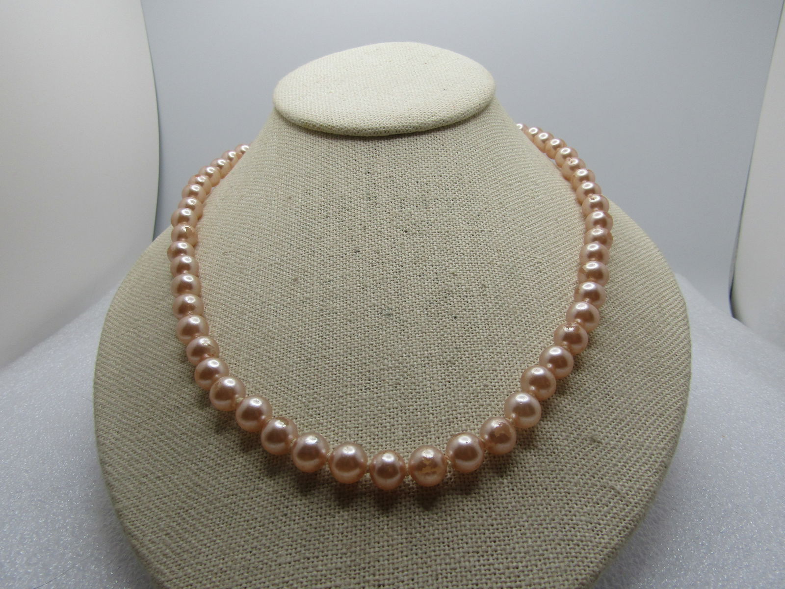 Vintage Blush Faux Pearl Necklace, 8mm 24", 1940's-1950's: Vintage Blush Faux Pearl Necklace, 8mm 24", 1940's-1950's. Silver tone floral blossom box clasp. The clasp wasmissing the pearl which has been added. The pearls are knotted between. Soem finish