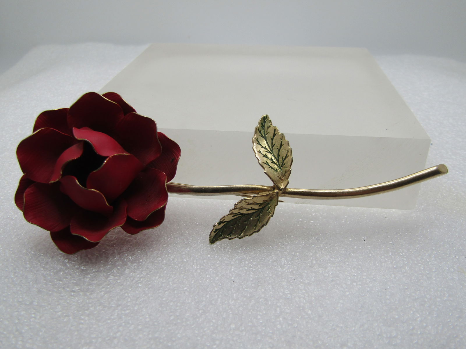 Vintage Red Enameled Long Rose Brooch, 1960's, 4.5": Vintage Red Enameled Long Rose Brooch, 1960's, 4.5". Very long stem with two leaves and a satiny red enameled blossom with the gold tips on the outline of the petals. It is not signed or marked. 