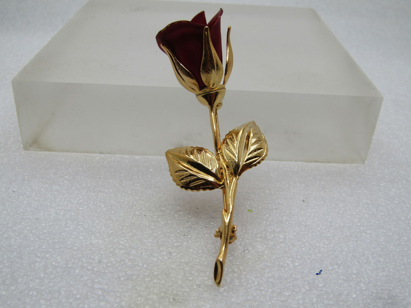 Vintage Red Long Stem Rose Brooch, 1960's-1970's, Signed: Vintage Red Long Stem Rose Brooch, 1960's-1970's, Signed. This is gold tone with a red matte blossom. The blossom curves upward slightly. It is appx. 3" tall and slightly over 1" wide. It is hard