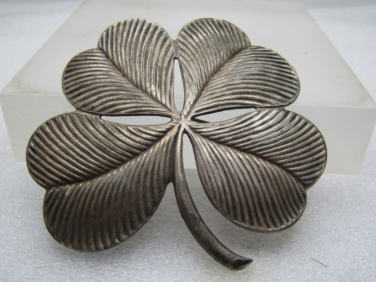 Vintage Four Leaf Clover Brooch, Shamrock, 2.75", 1940's: Vintage Four Leaf Clover Brooch, Shamrock, 2.75", 1940's. Great for St. Patrick's Day or any time. This has ridged petals to the shamrock with a curved stem. It is appx. 2.75" by 2.5". Slightly