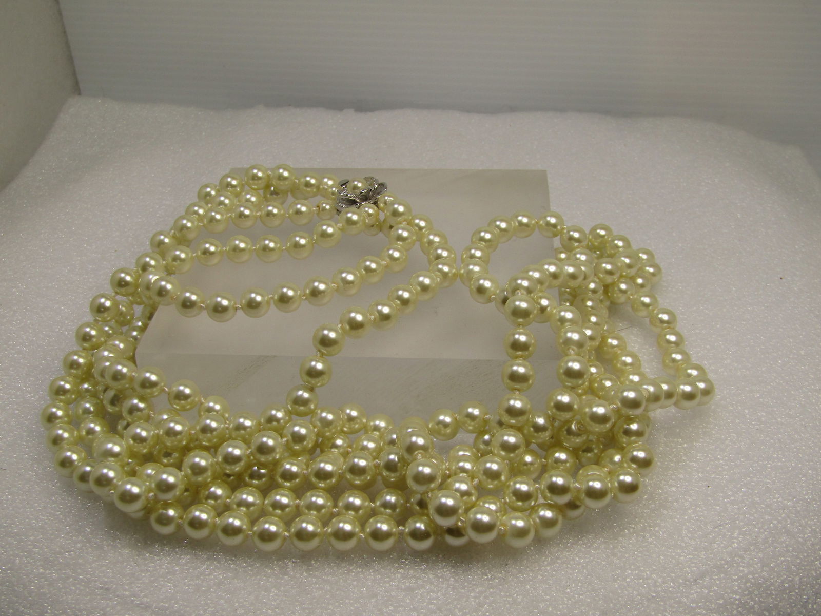 JBK Camrose & Kross Pearl Necklace, Triple Strand, Blossom with Pearl Box Clasp, 28", 30", and 32": JBK Camrose & Kross Pearl Necklace, Triple Strand, Blossom with Pearl Box Clasp, 28", 30", and 32" strands.. 1980's. Jacqueline Bouvier Kennedy, first lady from 1961 to 1963, Collection. The