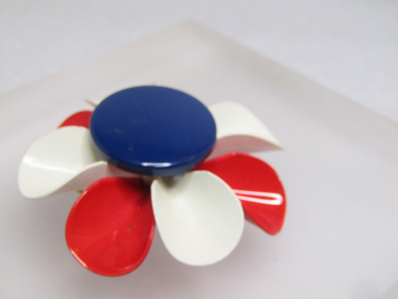 Vintage Red/White/Blue Blossom Brooch, Enameled, 1960's: Vintage Red/White/Blue Blossom Brooch, Enameled, 1960's. This is appx. 2.25" across with curled and rounded red and white petals and a 1" wide navy blue button top The brooch sits up high at appx.
