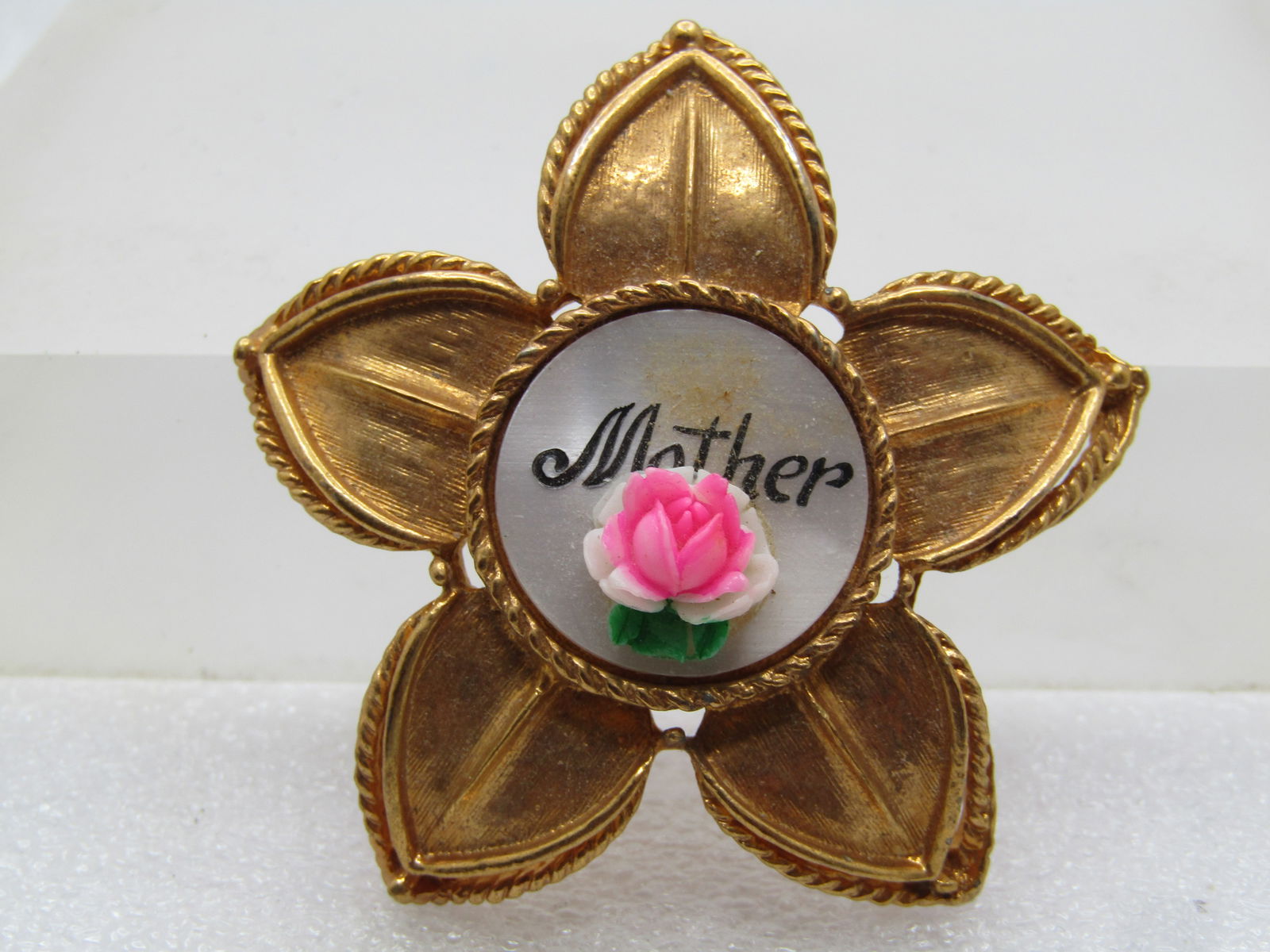 Vintage Mother Brooch, Rose an Faux MOP, 1950's-1960's: Vintage Mother Brooch, Rose an Faux MOP, 1950's-1960's. This is a heavy gold tone with a brushed finish and rope accent frames around each petal. It is slightly domed in the center and petals bend