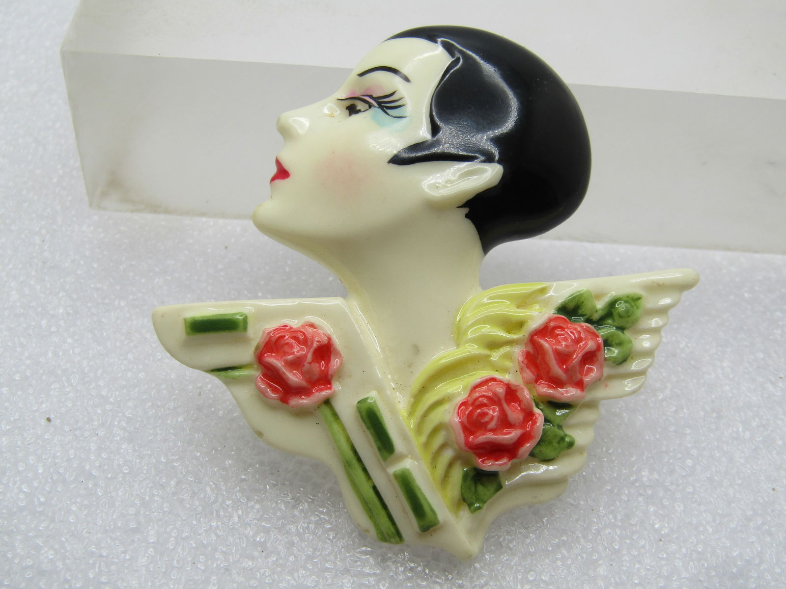 Vintage Art Deco/Flapper Brooch, with Flowers, 1960's-1970's: Vintage Art Deco/Flapper Brooch, with Flowers, 1960's-1970's. This is a plastic/acrylic brooch with a woman with a tight haircut, short and close to the head - black hair with lavender and blue eye