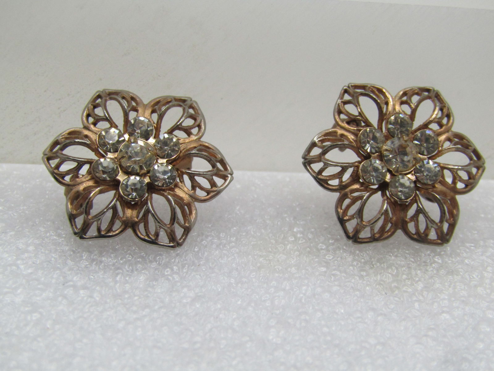 Vintage Pair Rhinestone Blossom Scatter Pins, 1940's-1950's: Vintage Pair Rhinestone Blossom Scatter Pins, 1940's-1950's. The earrings are appx. 3/4" across and blossom shaped in gold tone filigree with a clear rhinestone blossom cluster in the center. 