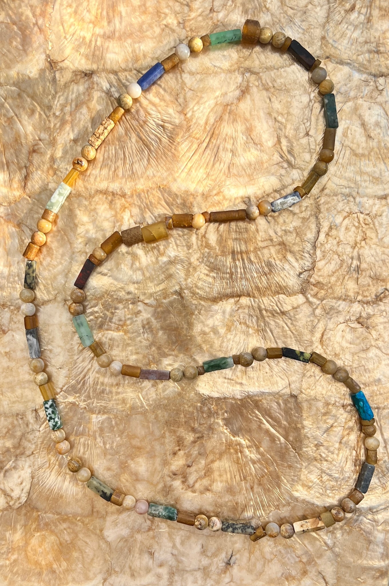 Beaded Assorted Agate Necklace: Title:Beaded Assorted Agate NecklaceDescription:Raw and Polished assorted Agate Beads make this a very special necklace. Brown, blue, green, grey and beige beads make it easy to wear with many items.