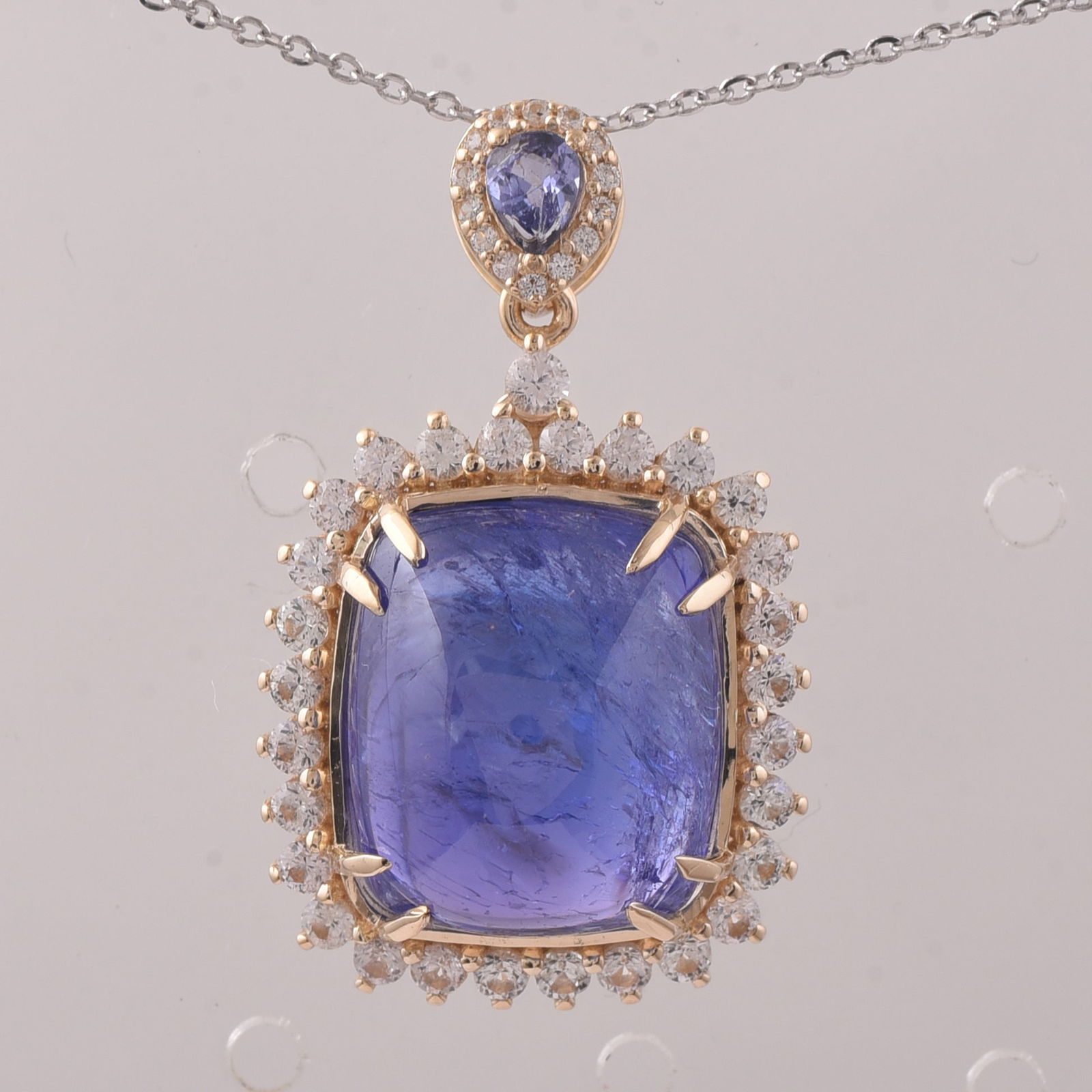 14.50 Ct Cushion Tanzanite 9K Gold Pendant: Title:14.50 Ct Cushion Tanzanite 9K Gold PendantDescription:14.50 Total Carat Tanzanite 9K Gold Pendant Specifications - Total Weight 4.914 g - Center Gemstone Tanzanite - Gemstone Carat Weight 13.46