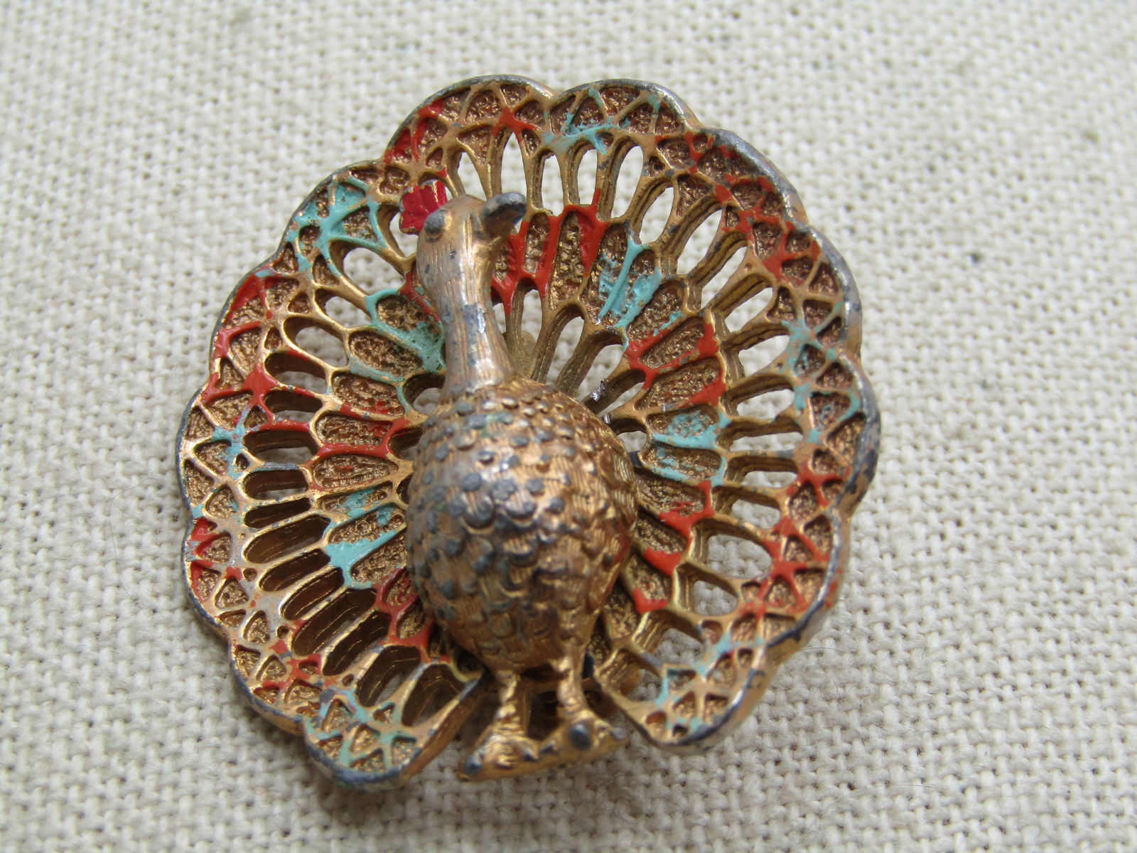 Vintage Enameled Peacock Brooch, Signed Jerry's, 1950's-1960's.: Vintage Enameled Peacock Brooch, Signed Jerry's, 1950's-1960's. Gold tone with a 1.5" height and appx. the same wide. The tail is open and spread wide with enameled accents in red and light blue. The