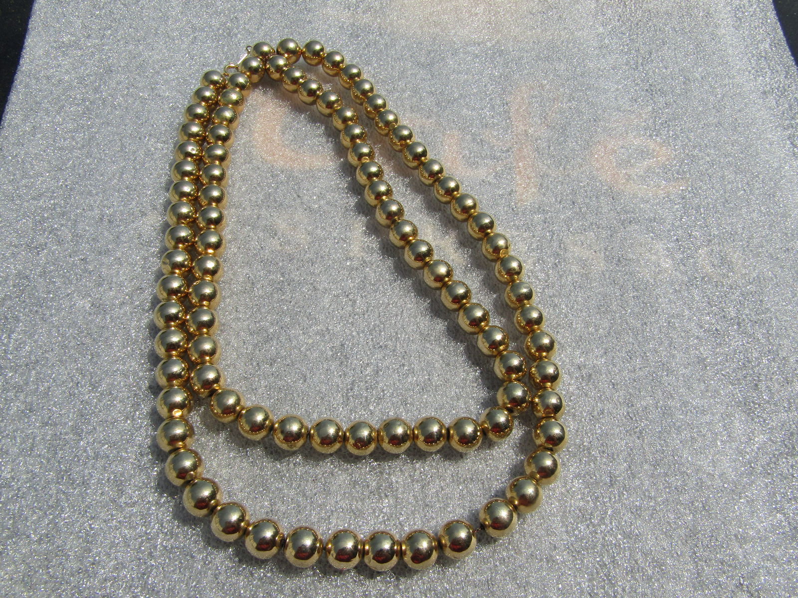 Vintage 10mm Gold Tone Beaded Necklace, 35", 1960's-1980's: Vintage 10mm Gold Tone Beaded Necklace, 35", 1960's-1980's. The beads are very shiny and a nice gold tone and strung on a metal chain with a spring ring. They are not signed or marked. The beads are h