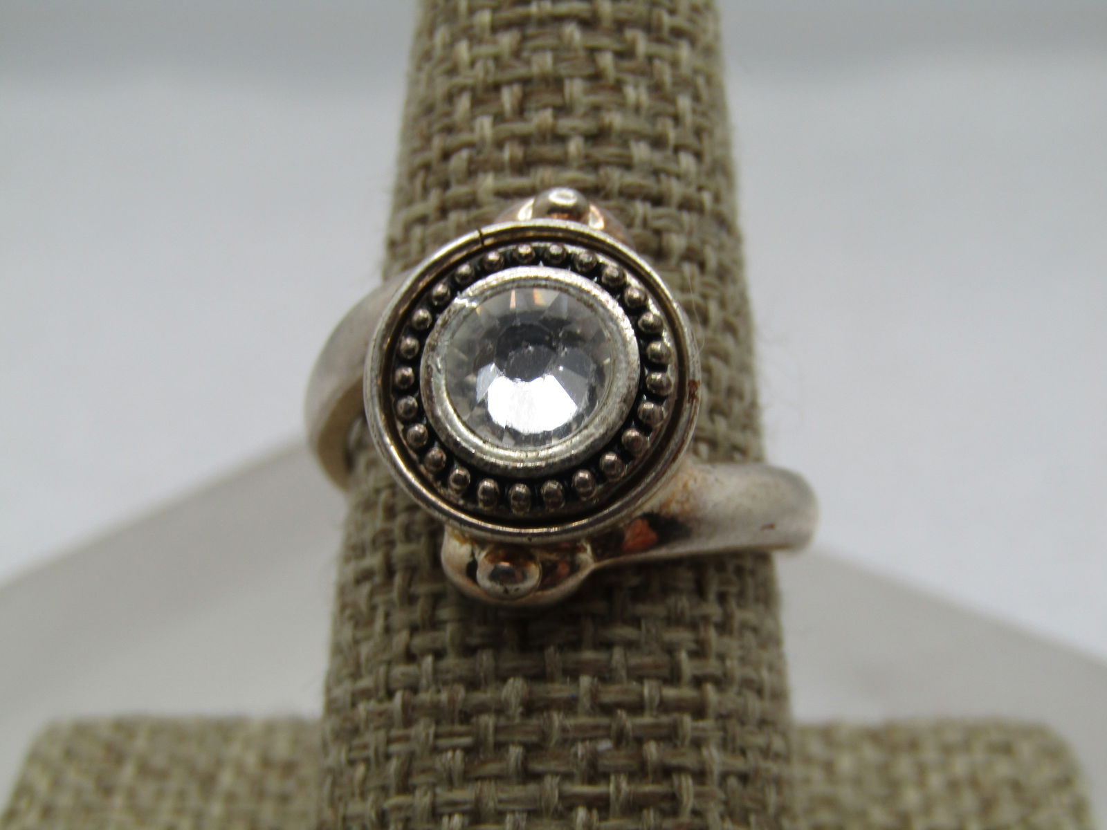 Vintage Bypass Clear Rhinestone Ring, Sz. 9, 1990's: Vintage Bypass Clear Rhinestone Ring, Sz. 9, 1990's. Silver tone Chunky 3.5mm to 4mm rounded band with a bead-like accent where it connects to the setting on top. It is offset, bypass style where