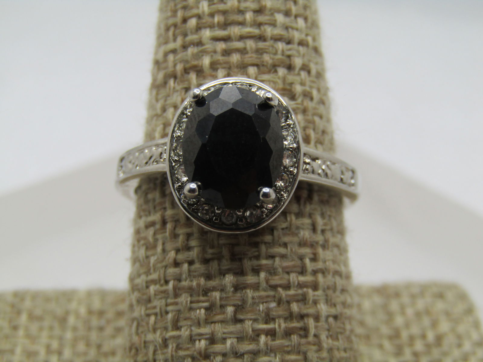 Silver Plated Hematite CZ Halo Ring, Sz. 9. 1990's-2000's: Silver Plated Hematite CZ Halo Ring, Sz. 9. 1990's-2000's. Black reflective oval 9.5mm by 7.5mm hematite, set higher than the halo and prong-set. The halo is wider than the hematite with appx.