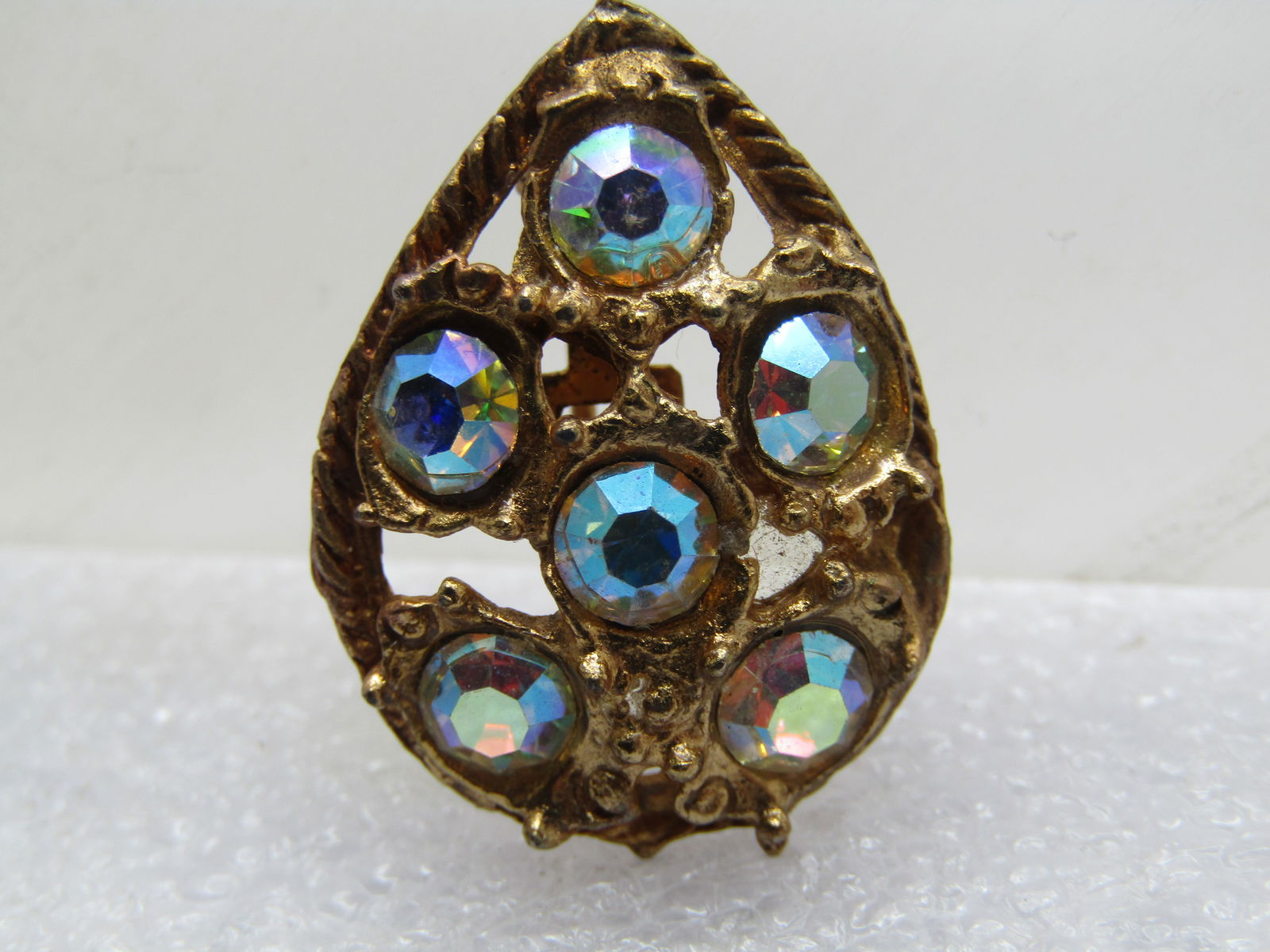 Vintage Aurora Borealis Rhinestone Brooch, 1950's, Pear-Shaped: Vintage Aurora Borealis Rhinestone Brooch, 1950's, Pear-Shaped. Six clear aurora borealis stones that are appx. 4mm are set in thise stone with open work around them. Gold tone frame that domes