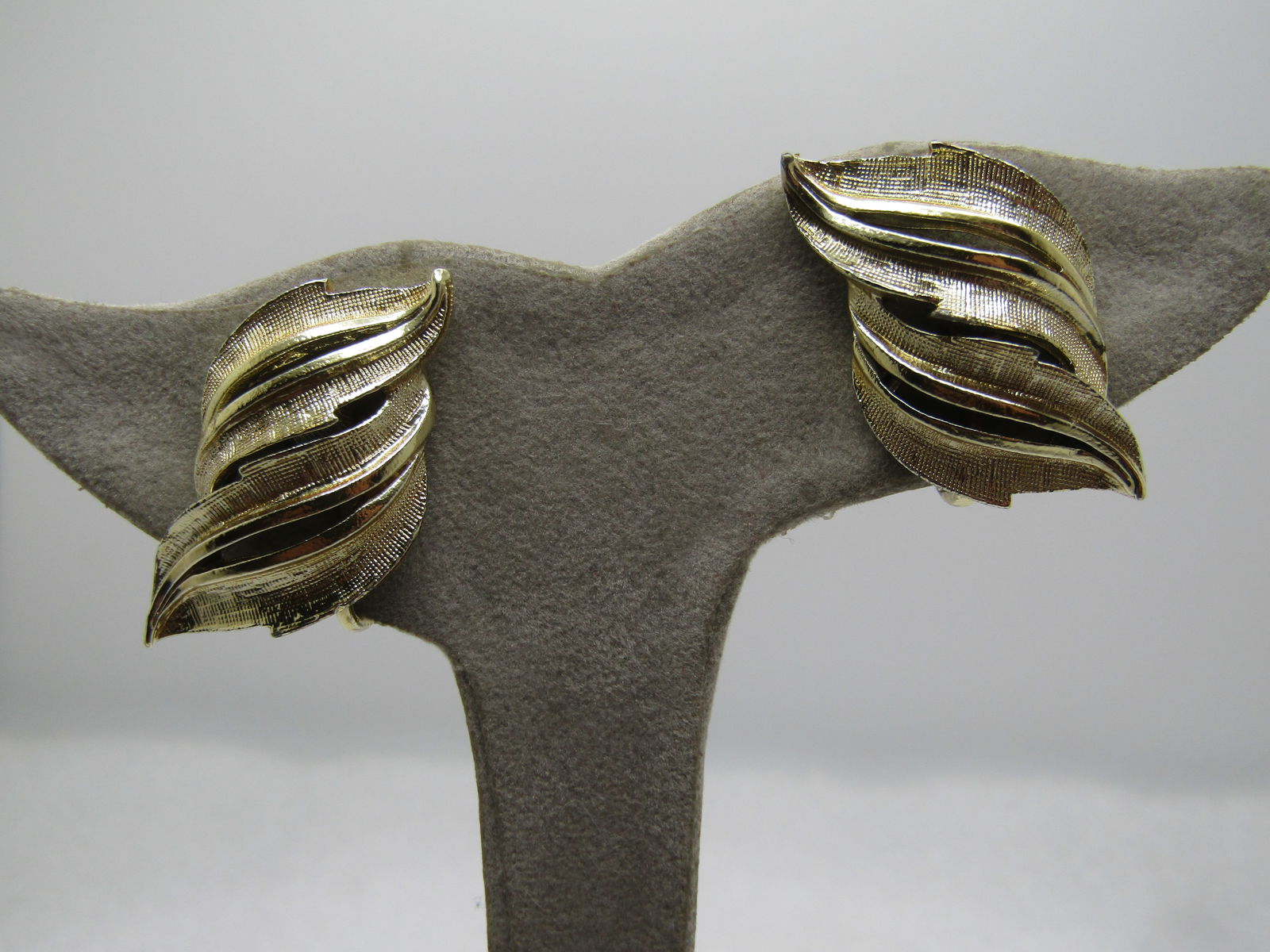 Vintage Coro Curved Earrings, Clip, Leaf-like, 1960's: Vintage Coro Double Open Leaf Earrings, Clip, 960's. Gold tone with two textured leaves with open work and smooth and textured finish,. Hinged clips. Signed Coro on the back. Gold tone. They are