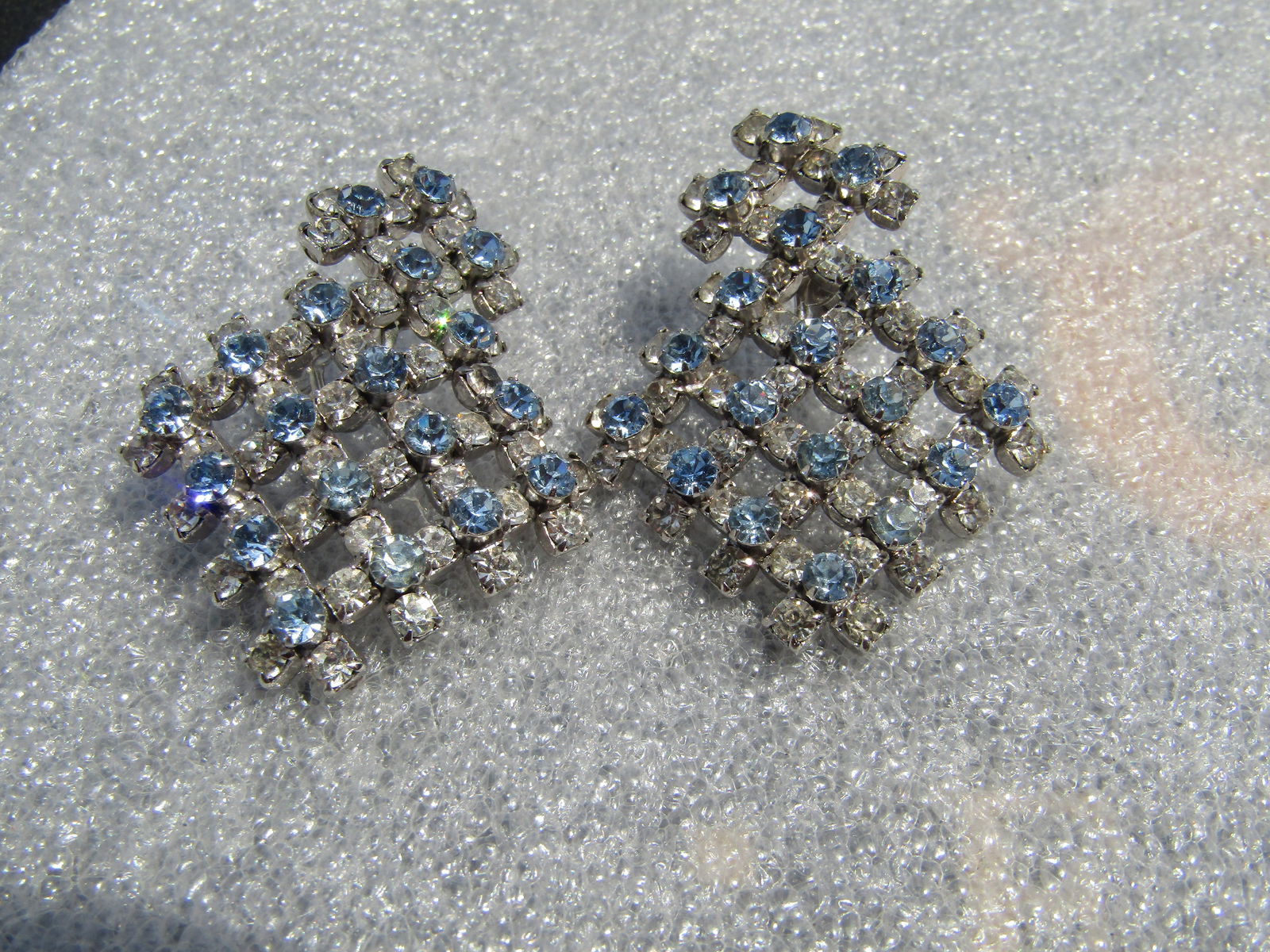 Vintage Blue & Clear Open Raised Grid Earrings, Screwback, 1960's: Vintage Blue & Clear Open Raised Grid Earrings, Screwback, 1960's. The top is a solid grid of blue glass rhinestones on top and clear below and is appx. 3/4" wide. Attached to that is a matching large