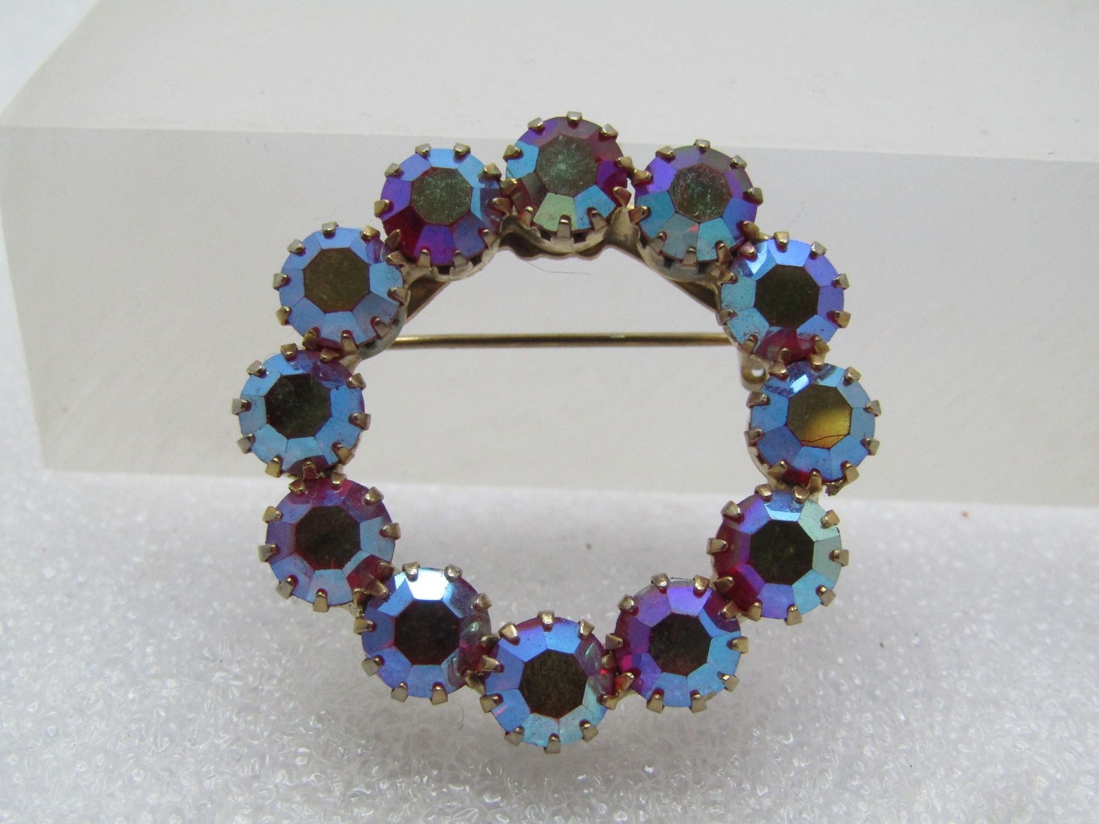 Vintage Red Aurora Borealis Rhinestone Brooch, 1960's.: Vintage Red Aurora Borealis Rhinestone Brooch, 1960's. Gold tone red 6mm AB rhinestone circle brooch. The stones are prong set. Appx. 1-1/8" round. Locking clasp. Not signed or marked by the maker. Ve