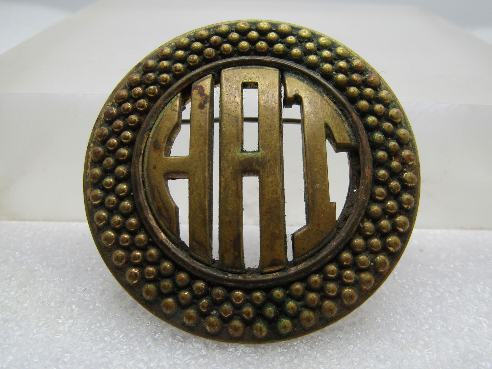 Vintage Monogrammed Brooch - HAI or HAT or HAJ - Signed Monocraft, 1930's: Vintage Monogrammed Brooch - HAI or HAT or HAJ - Signed Monocraft, 1930's. Monocraft went to to become Monet in 1937. This is a Brassy gold tone round brooch with three rows of beaded like acdents