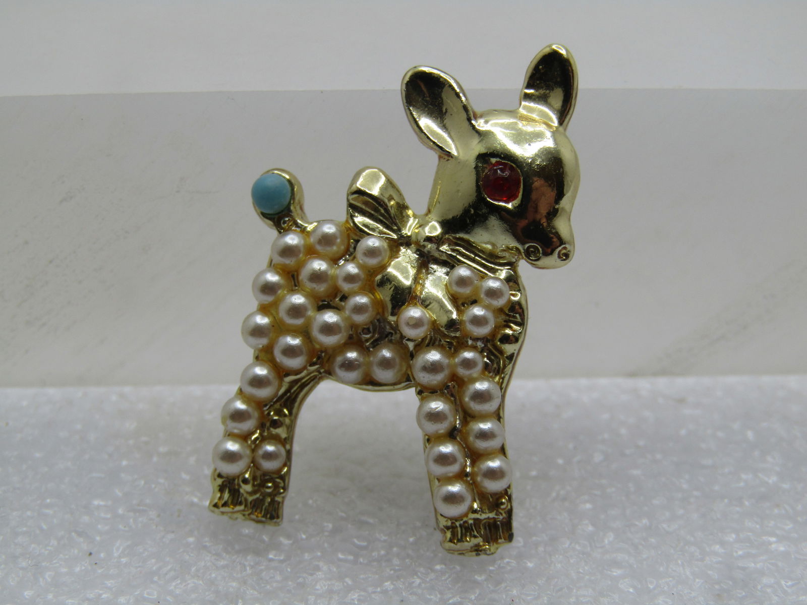 Vintage Faux Pearl Baby Lamb Brooch, 1950's-1960's: Vintage Faux Pearl Baby Lamb Brooch, 1950's-1960's. Red rhinestone eye and turquoise blue tail. White faux pearls cover the body. Some pearls were added after photos. 1.25" tall at 1" wide. Gold tone