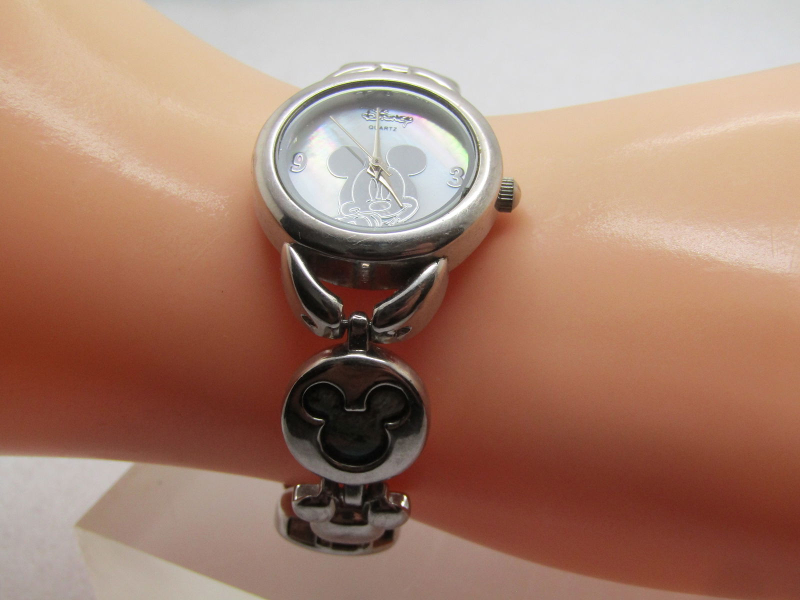 Vintage Mickey Mouse Watch, Inlaid Shell Band, Accutime, 1990's: Vintage Mickey Mouse Watch, Inlaid Shell Band, Accutime, 1990's or after. . Silver tone with a bracelet style band that has alternating solid smaller Mickey head shaped links and a larger inlaid with