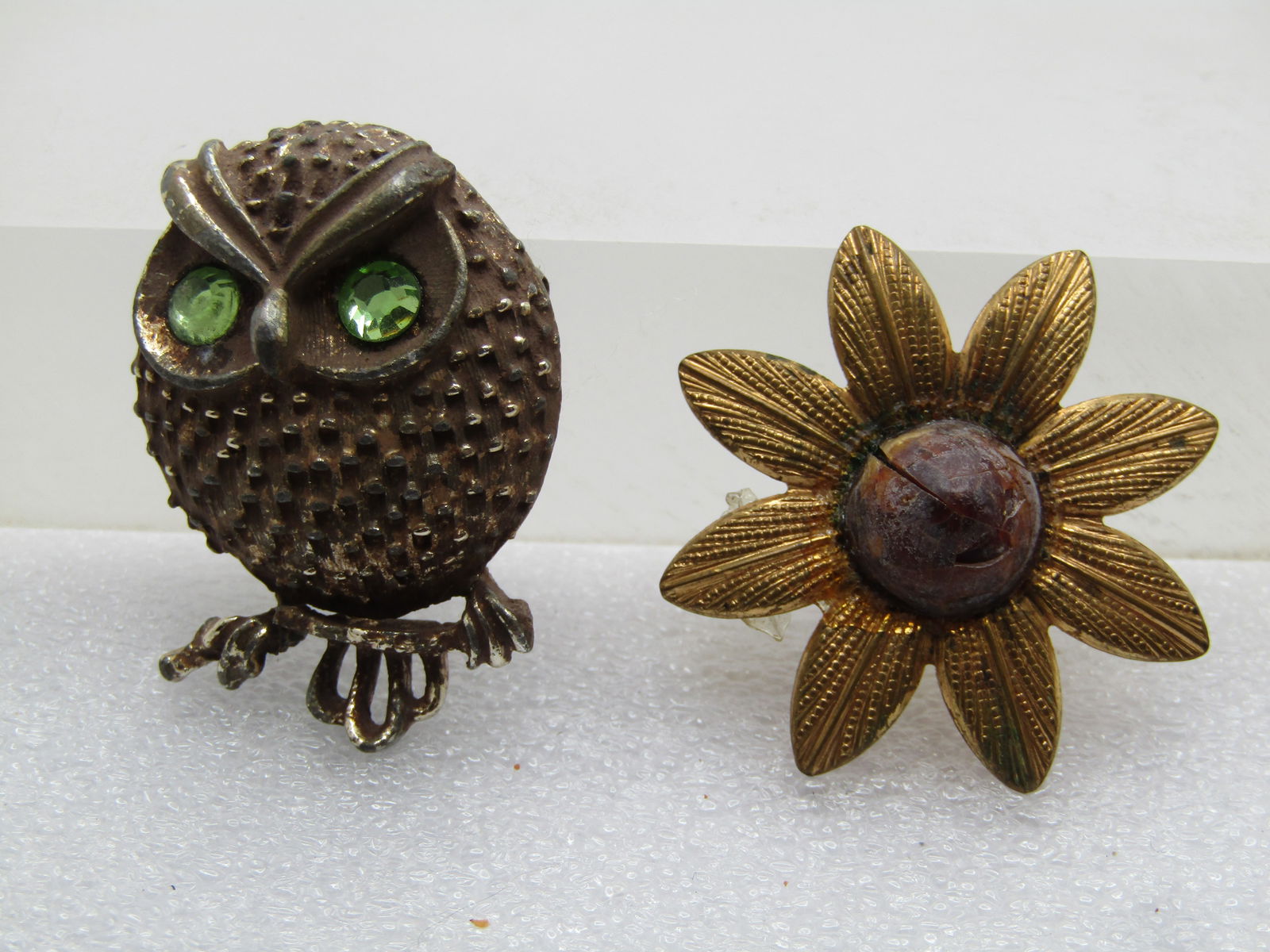 Vintage Pair of Brooches, Owl & Blossom, 1940's/1960's: Vintage Pair of Brooches, Owl & Blossom, 1940's/1960's. The blossom is a 1940's gold tone blossom with a rounded and pointed molded stone in the center - it has the look of a plastic that is amber