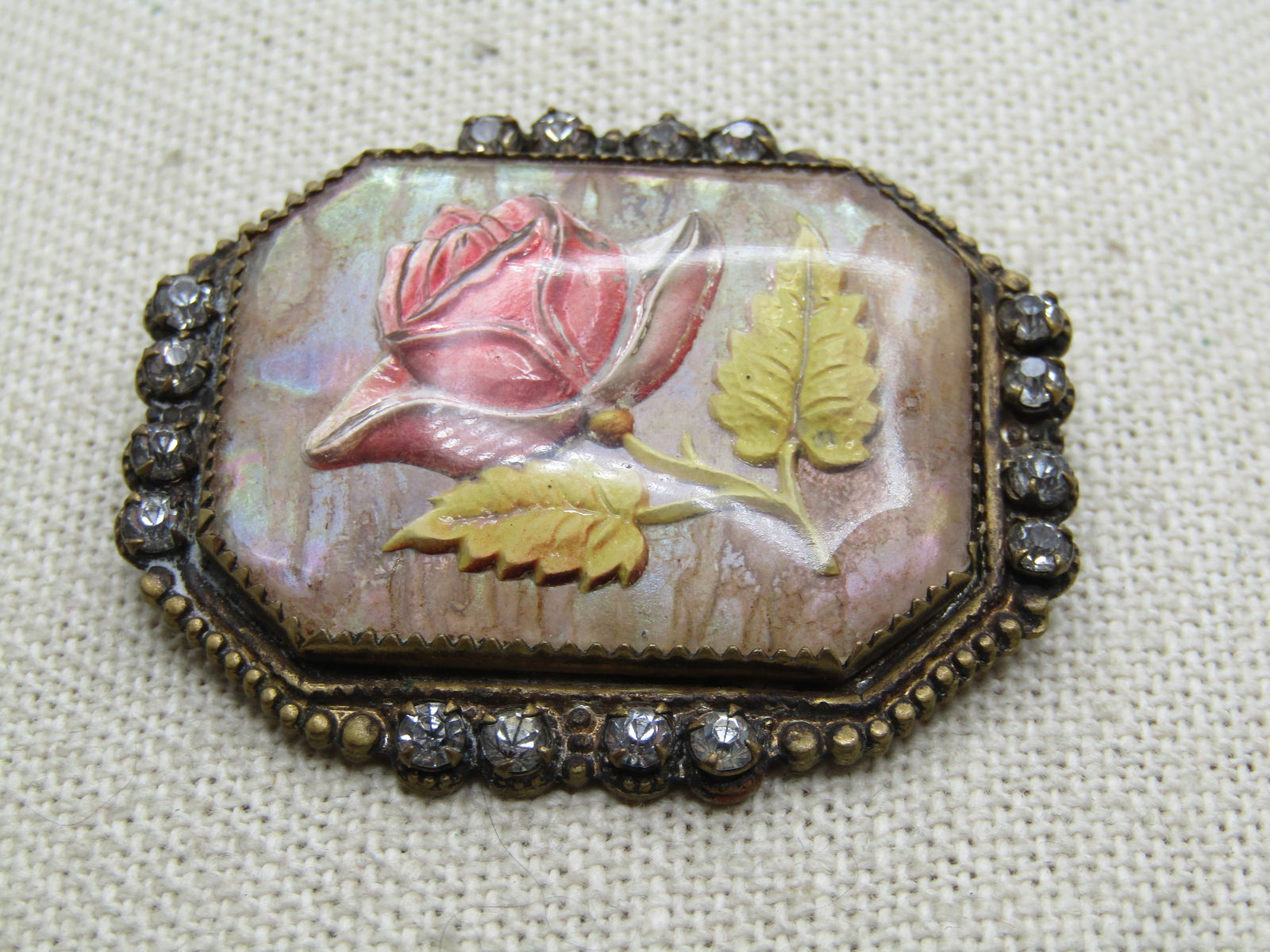 Antique Essex Glass Rose Carved Brooch, 1910's, Rhinestones: Antique Essex Glass Rose Carved Brooch, 1910's, Rhinestones. Closed back with a pale coral rose and yellow leaves - reversed carved with solid parchment toned back and domed faceted glass. Framed with