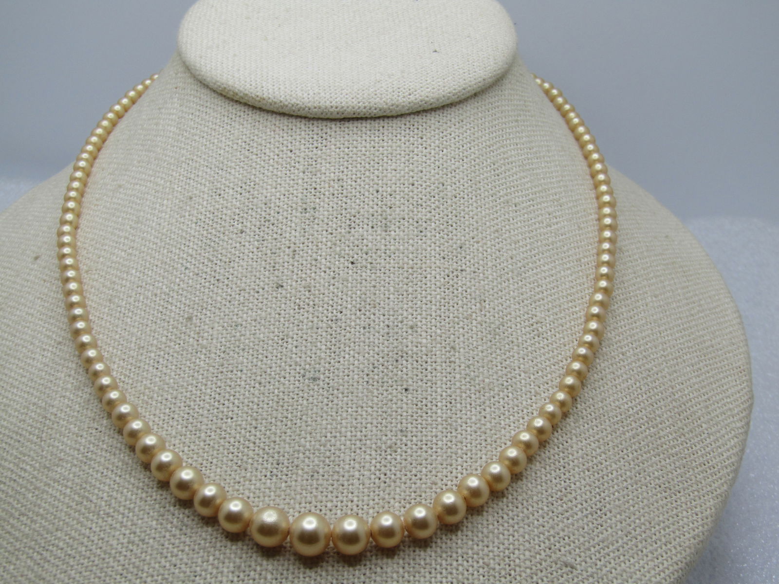 Vintage Graduated Faux Pearl Necklace, Sterling Silver Clasp, 17.5", 1940's-1950's, Signed.: Vintage Graduated Faux Pearl Necklace, Sterling Silver Clasp, 17.5", 1940's-1950's. The pearls are graduated from appx. 3mm to 7mm. It is 17.5" long with an open filigree cateye box clasp where it