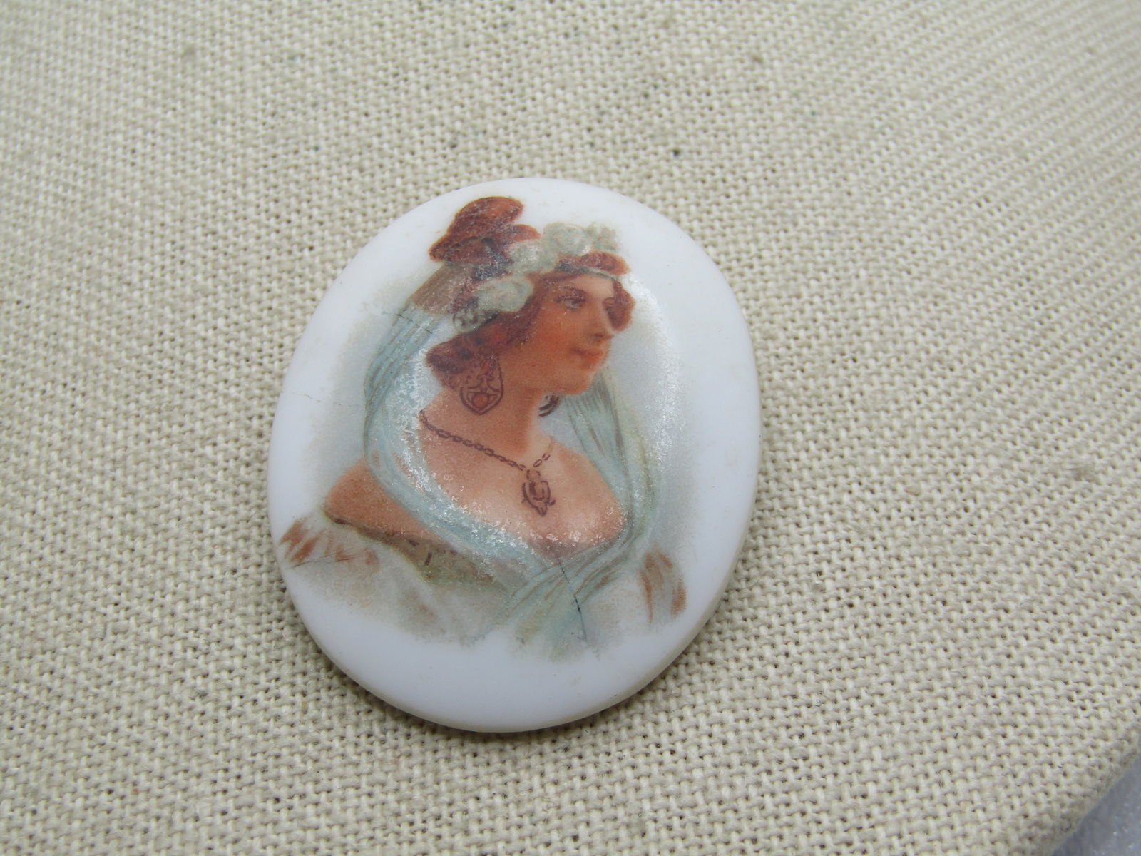 Vintage Painted Woman Brooch, Cameo-ish, C-Clasp Early 1900's: Vintage Painted Woman Brooch, Cameo-ish, C-Clasp Early 1900's. Oval and appx. 1.75" by 1.5" domed white glass with a painted woman in Victorian style clothing. It is in very good condition. It is