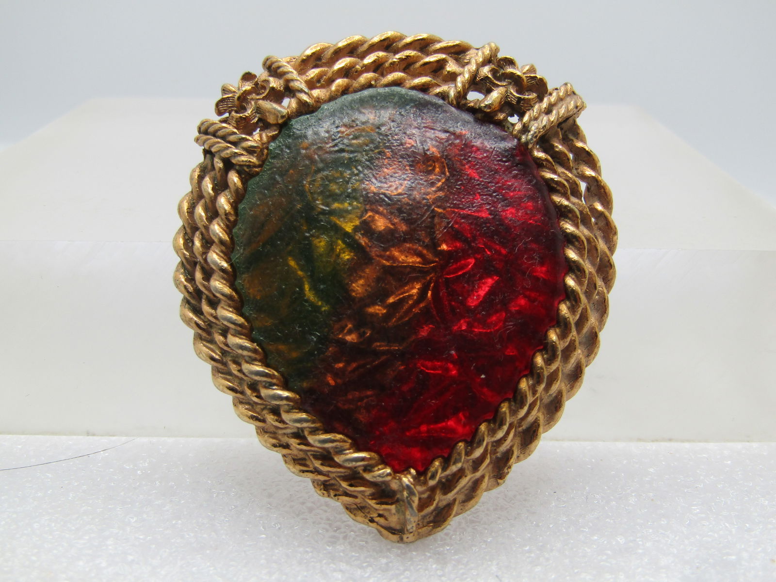 Vintage Multi-Colored Foiled Brooch, 1950's-1960's: Vintage Multi-Colored Foiled Brooch, 1950's-1960's. Gold tone. Heavy nThis has a crumpled foil background with a transparted multi-colored acrylic top in green, amber and red in a pear-shape that is