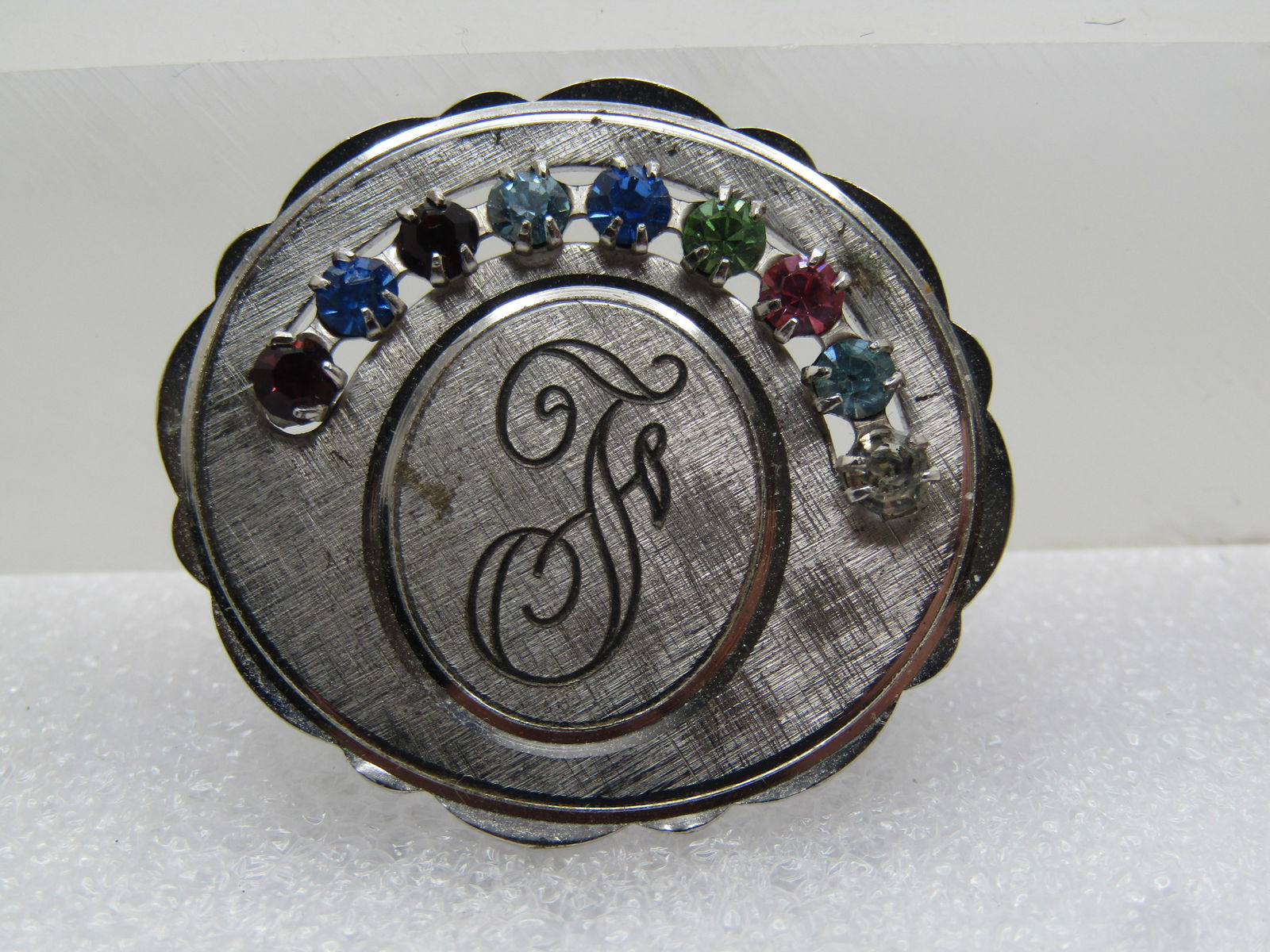 Vintage Sterling Initial F Brooch & Rhinestones, 1960's-1970's, Signed: Vintage Sterling Initial F Brooch & Rhinestones, 1960's-1970's, Signed. Textured oval design with bright and shiny frame and oval around the Initial F. It has none rhinestones - likely birthstones