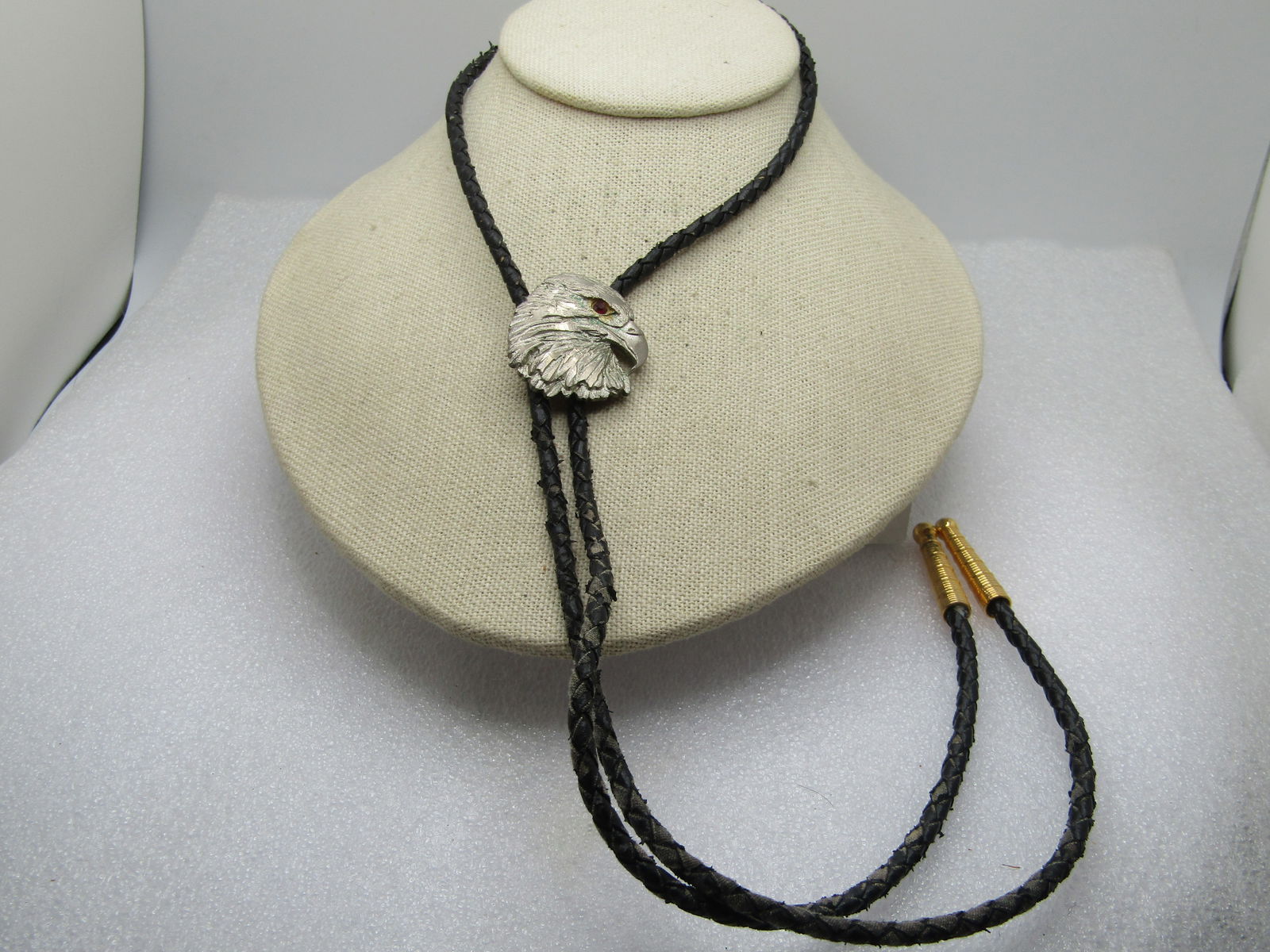 Vintage Silver Eagle Head Bolo Tie, Black Braided 36", 1960's-1970's: Vintage Silver Eagle Head Bolo Tie, Black Braided 36", 1960's-1970's. This has a silver tone eagle head slide, possibly pewter eagle that looks carved with a red rhinestone eye. It is appx. 1.25"