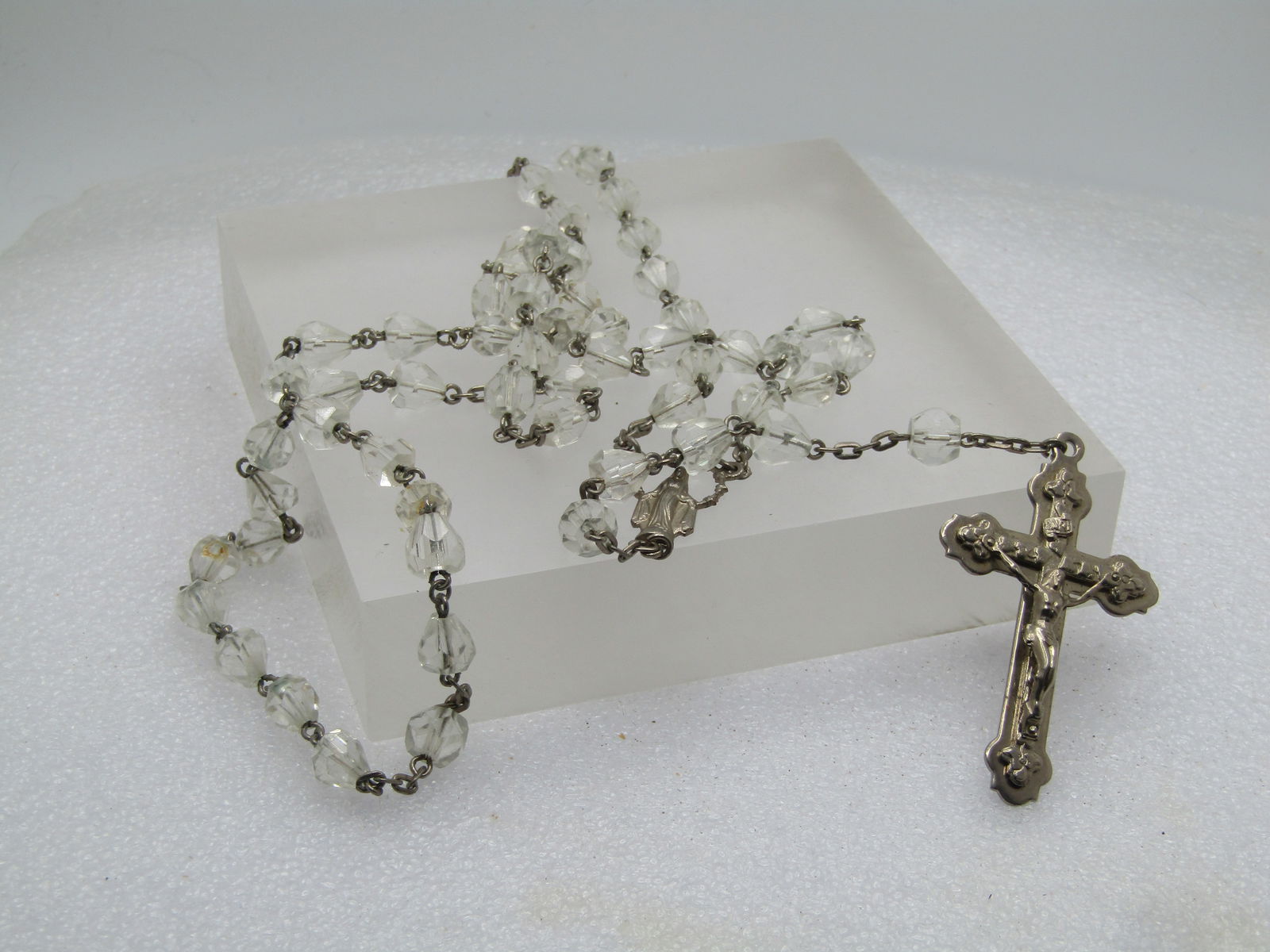 Vintage 36" Clear Beaded Rosary, 1950's-1960's: Vintage 36" Clear Beaded Rosary, 1950's-1960's. the loop of the rosary is 30" with 6" additional length for the crucifix and beads. Silver tone with a Madonna at the intersection. It is not marked