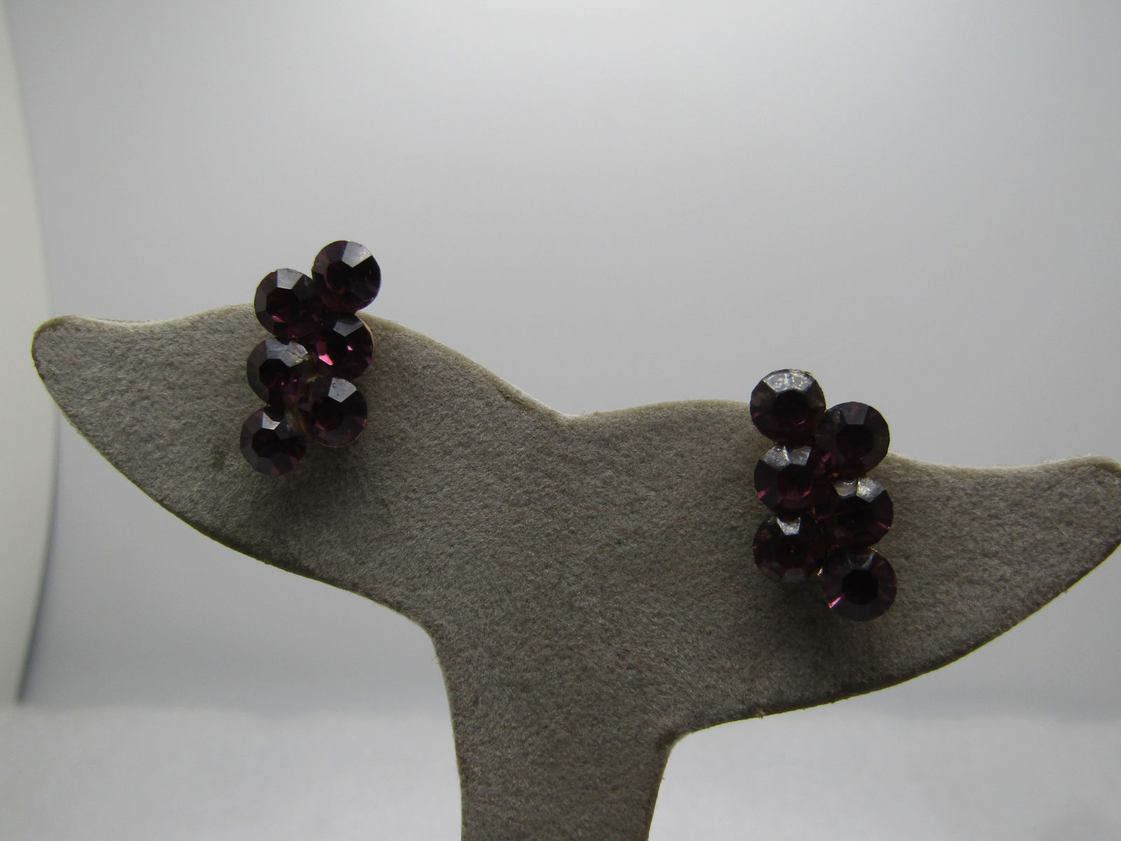 Vintage Purple Rhinestone Cluster Earrings Screwback 1940's-1950's.: Vintage Purple Rhinestone Cluster Earrings Screwback 1940's-1950's. Gold tone with two rows of 5mm purple rhinestones that are staggered in height. The earrings are appx. 3/4" tall by 1/2" wide. Some