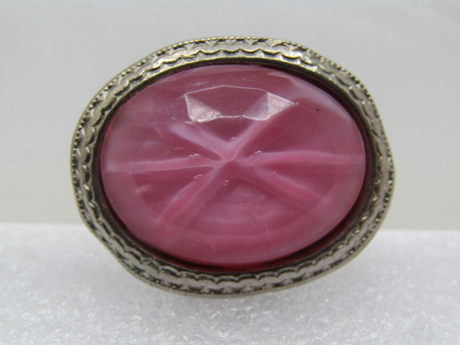 Vintage Faux Pink Sapphire Brooch, C-Clasp, 1940's-1950's: Vintage Faux Pink Sapphire Brooch, C-Clasp, Silver tone oval brooch with c-clasp, 1940's-1950's. Silver tone with a design in the frame and a lightly faceted faux pink sapphire stone in the center. Th
