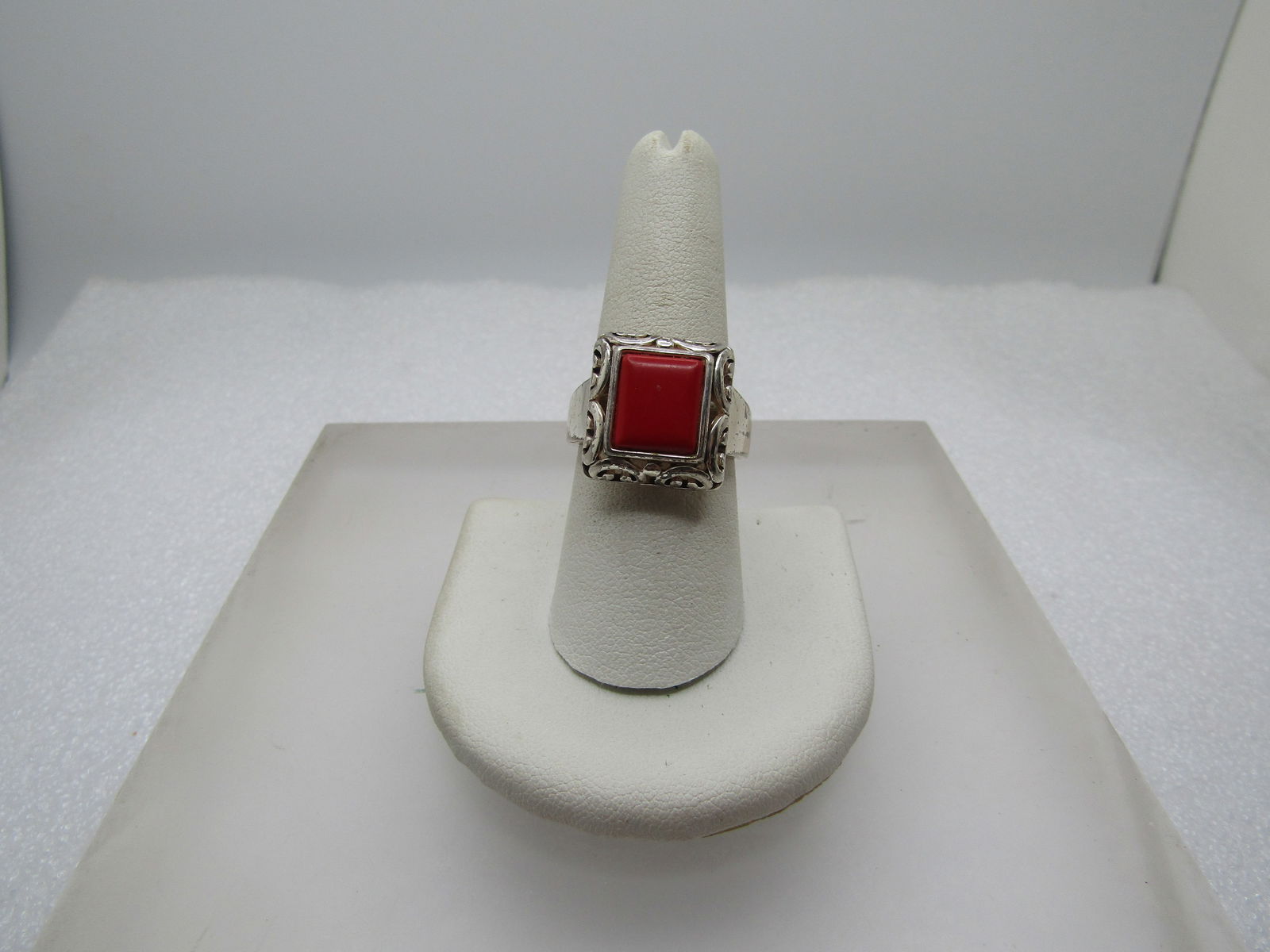 Silver Tone Faux Coral ring, Sz. 8.5, 1990's, Scrolled: Silver Tone Faux Coral ring, Sz. 8.5, 1990's, Scrolled. Rectangular angled open scrolled design with a 9.5mm by 8.5mm faux red coral acrylic insert. The top of the ring is appx. 16mm by 15.5mm. 