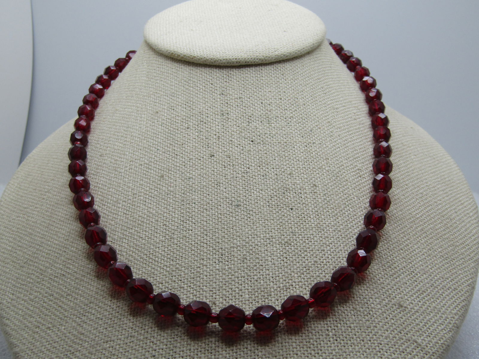 Vintage Red Faceted Beaded Necklace, 18", 1960's-1970's: Vintage Red Faceted Beaded Necklace, 18", 1960's-1970's. Appx. 6mm garnet red glass or crystal beads that hav a slightly lighter spacer bead between. Gold tone twist clasp. Very appealing and in very