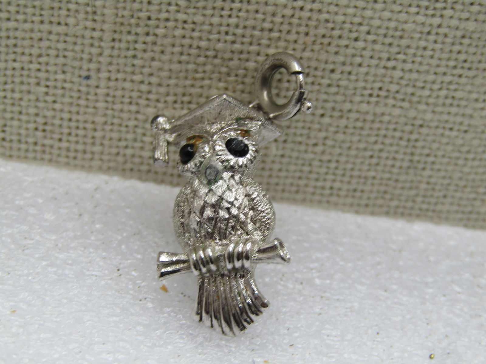 Vintage Monet Owl Charm/Pendant, 1960's: Vintage Monet Owl Charm/Pendant, Spring Ring, 1960's. This is appx. 1-3/8" long and 5/8" wide. The owl has black beaded glass eyes. Silver tone. Very clean and in very good condition. Great on a