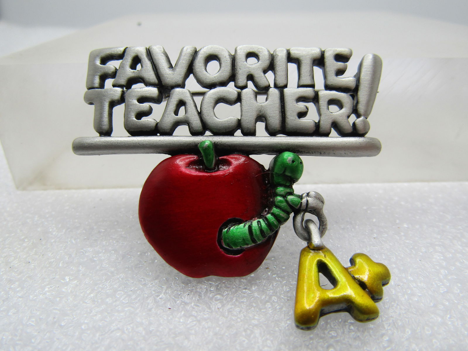 Vintage Favorite Teacher Brooch, Dangling Charms. Signed JJ 1980's-1990's: Vintage Favorite Teacher Brooch, Dangling Charms. Signed JJ 1980's-1990's. Pewtertone brooch with Favorite Teacher in two lines spelled out in block letters with an !. Below that is an underscore with