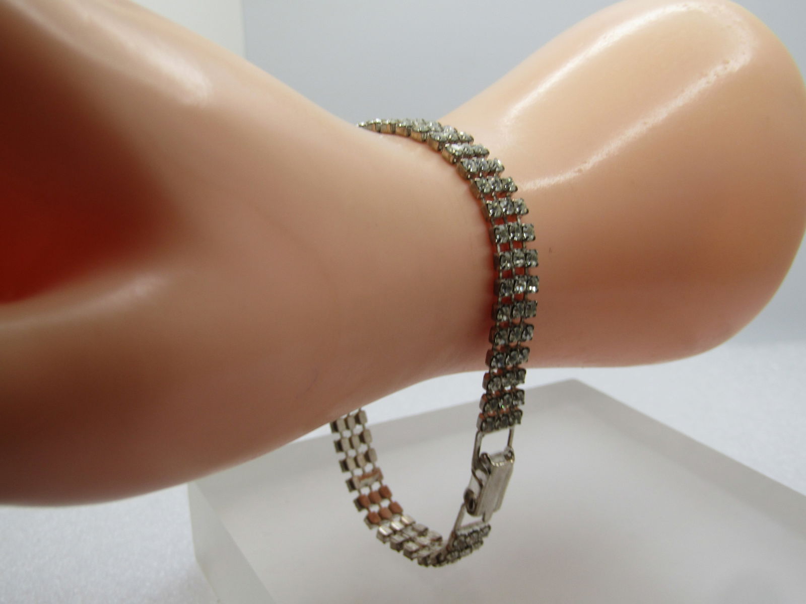 Vintage Clear Rhinestone Bracelet, Triple Strand, 8" 1960's-1980's: Vintage Clear Rhinestone Bracelet, Triple Strand, 8" 1960's-1980's. Silver tone with a flip clasp. It is appx. 3/8" wide. Very clear and clean stones. Bracelet is in very good condition. It is not sig