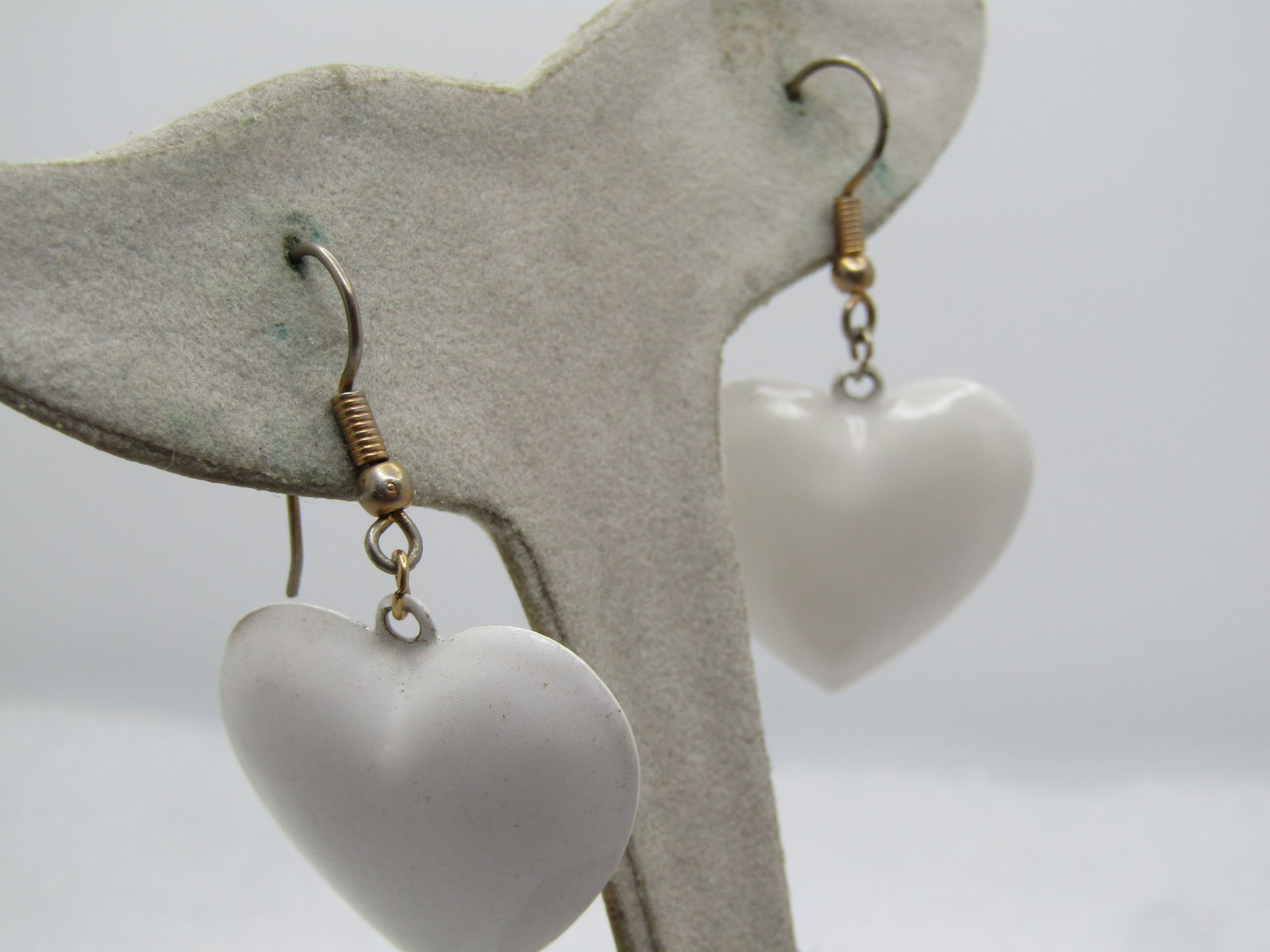 Vintage White Enameled Hear Earrings, 1960's, Pierced: Vintage White Enameled Hear Earrings, 1960's, Pierced. These are dangle hearts that are domed and enameled in white. The heart is appx. 1-1/8" long and 1" wide with gold tone hook post. They are