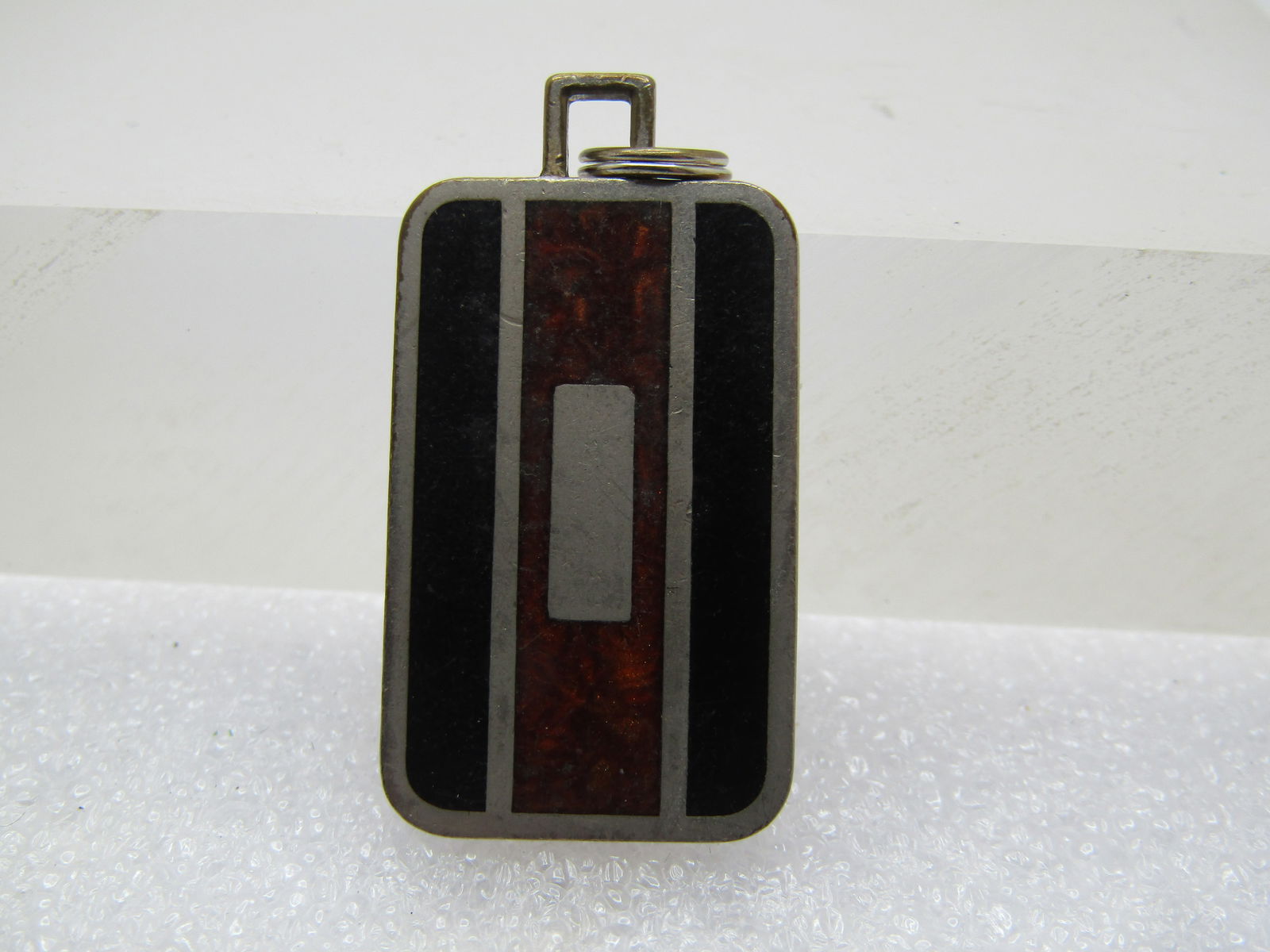 Vintage Black & Brown Inlaid Pendant, signed Colibri, 1970's-1980's: Vintage Black & Brown Inlaid Pendant, signed Colibri, 1970's-1980's. It is rectangular and a unisex design. Silver tone with inalid black on the sides and a swirled brown in the center. It is