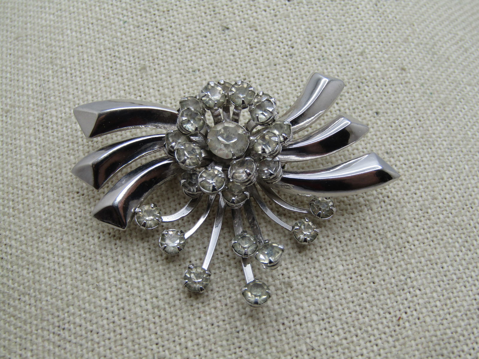 Vintage Clear Rhinestone Flared Brooch/Pendant, 1940's-1960's: Vintage Clear Rhinestone Flared Brooch/Pendant, 1940's-1960's. Silver tone with a center tiered circle of clear rhinestones around a recessed appx. 6.5mm clear rhinestones. The stones in the tier and