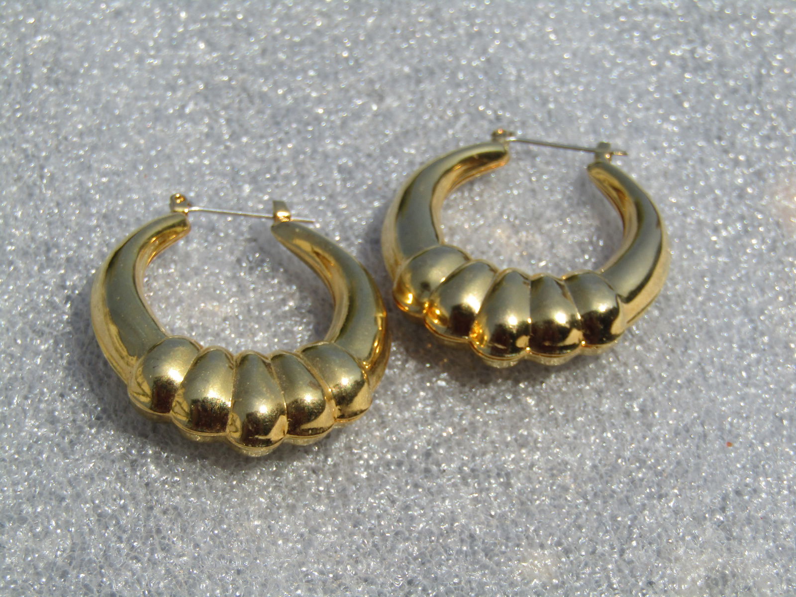 Vintage Puffy Gold Tone Hoop Earrings, Pierced, 1980's-1990's: Vintage Puffy Gold Tone Hoop Earrings, Pierced, 1980's-1990's. These have a grduated banded wrap at the bottom and are tapered to thinner at top. They are a hollow gold tone metal design with a hinged