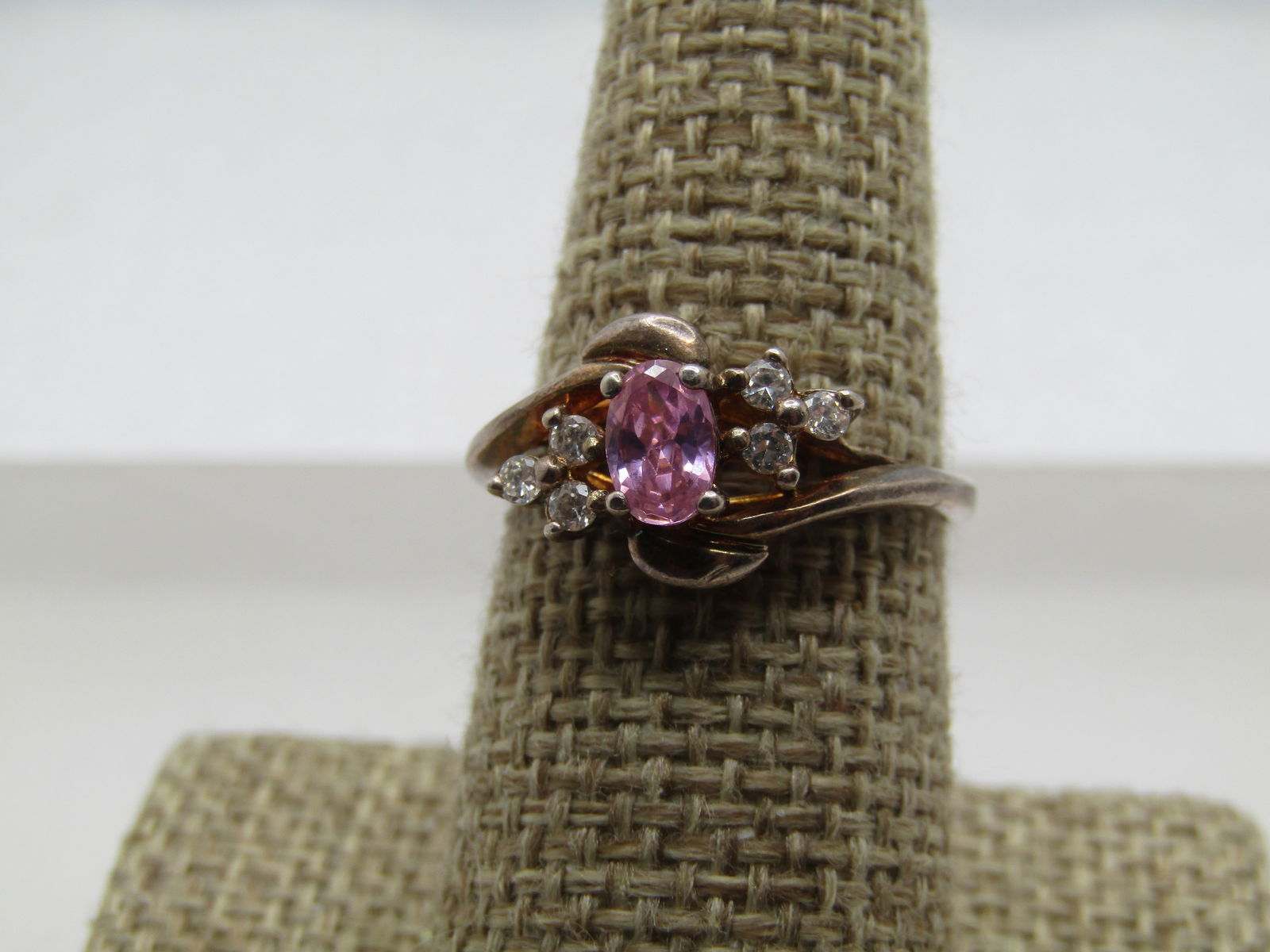 Vintage Pink & Clear Stone Ring, Sz. 8.5, Signed RJ. 1970's: Vintage Pink & Clear Stone Ring, Sz. 8.5, Signed RJ., 1970's. Bypass band design with on band on the top of the setting, and the other at the bottom. this has a center pink stone that is appx.